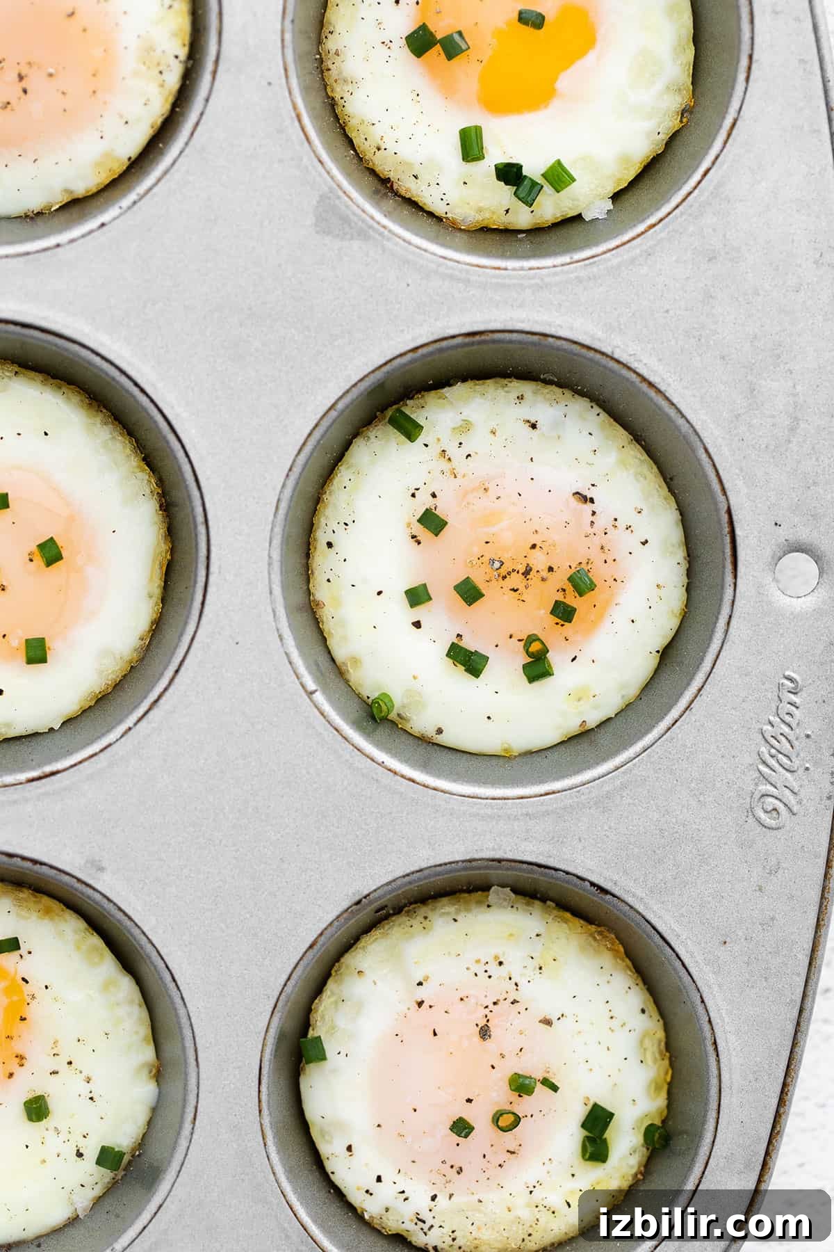 Bake eggs in oven using muffin tin and chives.