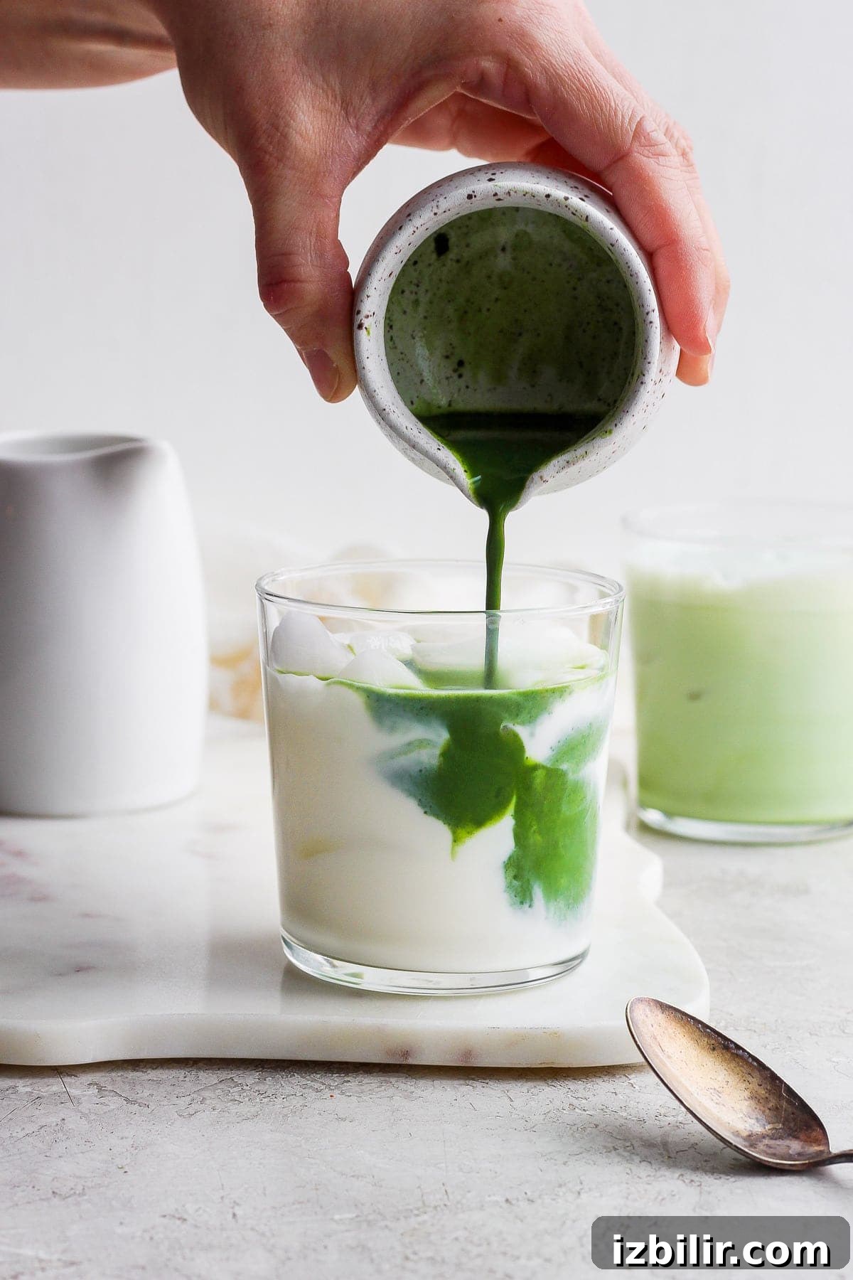 How to Make an Iced Matcha Latte at Home 2 Pouring matcha mixture into the almond milk.