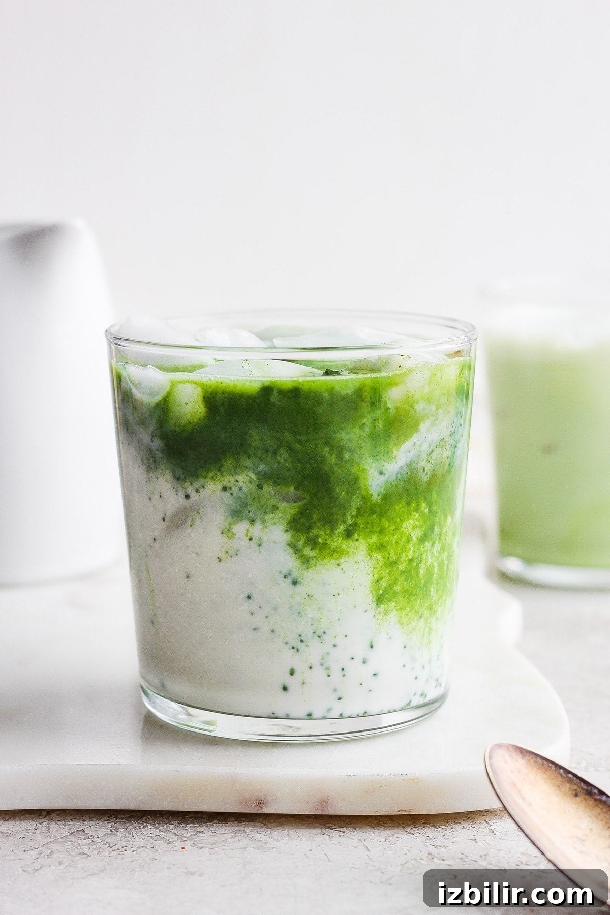 How to Make an Iced Matcha Latte at Home 5 Iced latte with a matcha swirl in almond milk.
