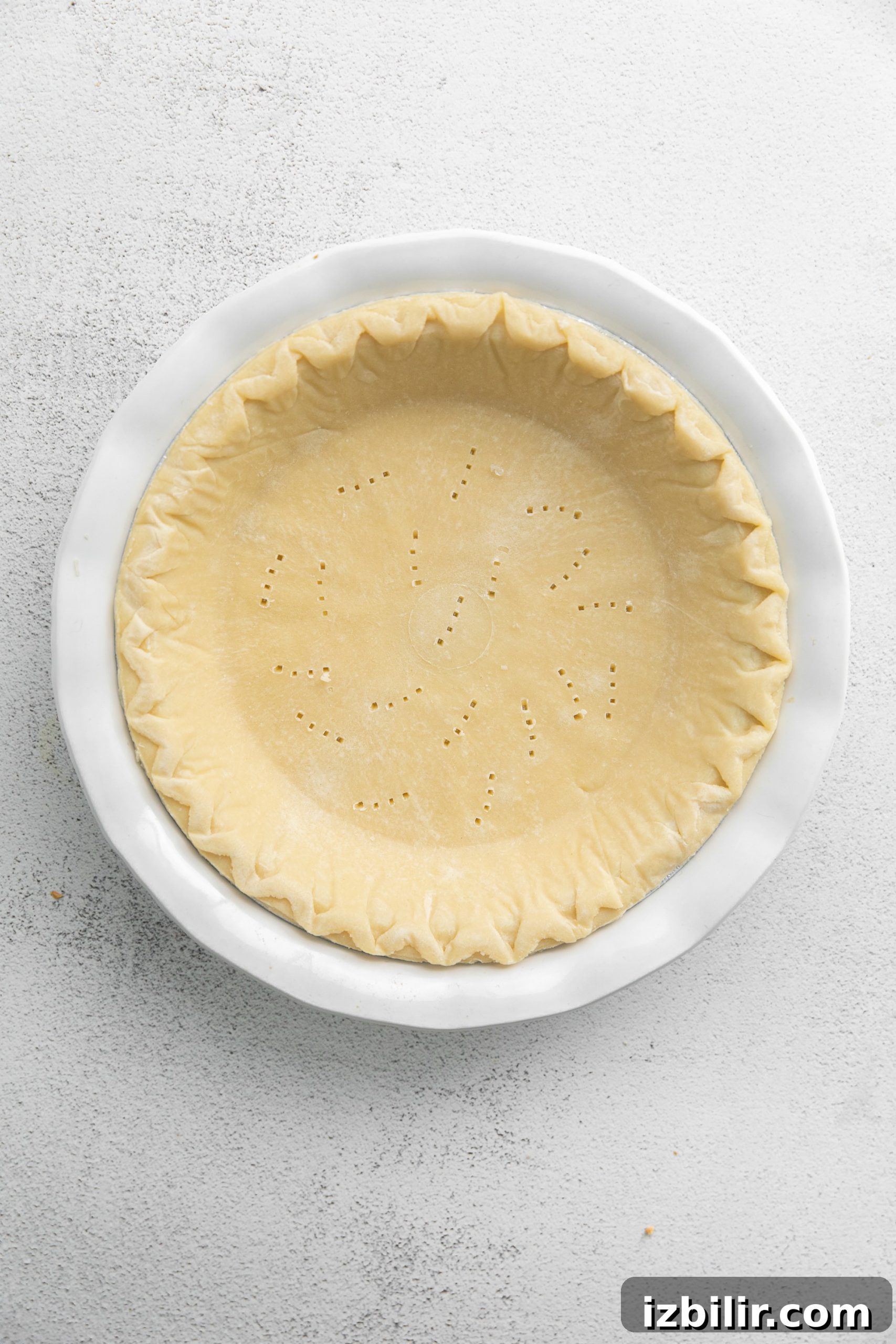 Spinach Quiche Recipe with Flaky Pastry Crust 4 Quiche crust with holes in the bottom.