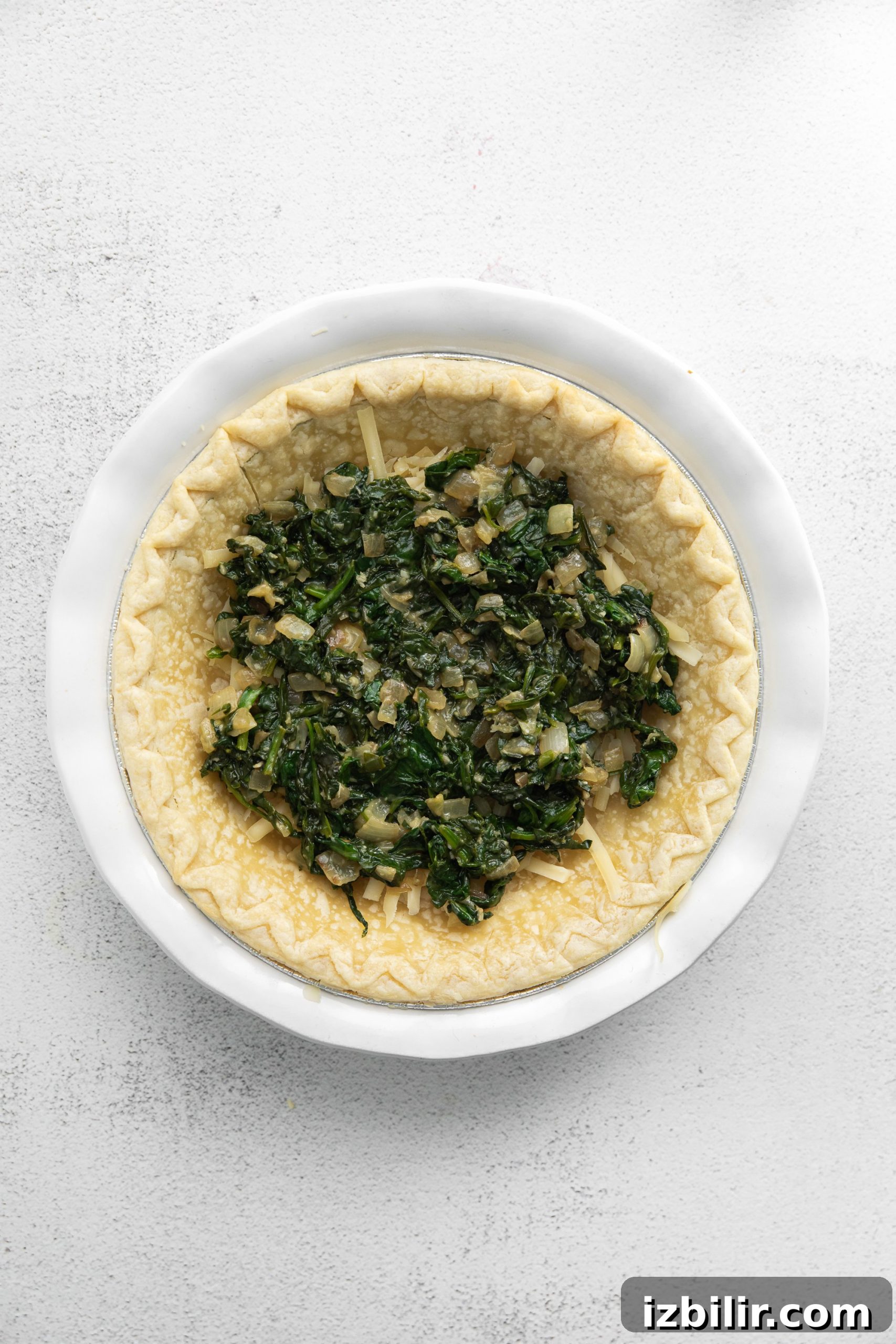 Spinach Quiche Recipe with Flaky Pastry Crust 5 Spinach, onions, and garlic in a quiche crust.