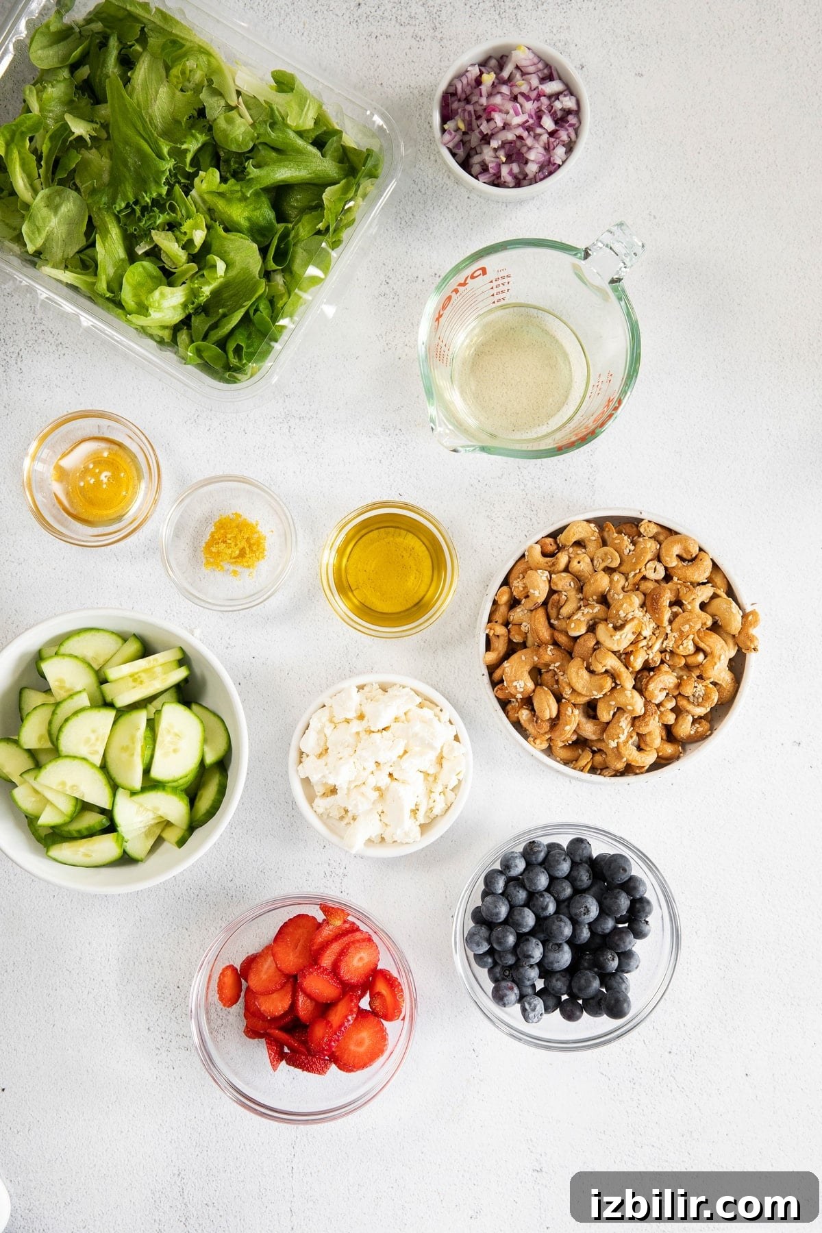 All of the ingredients for a spring mix salad in small bowls.