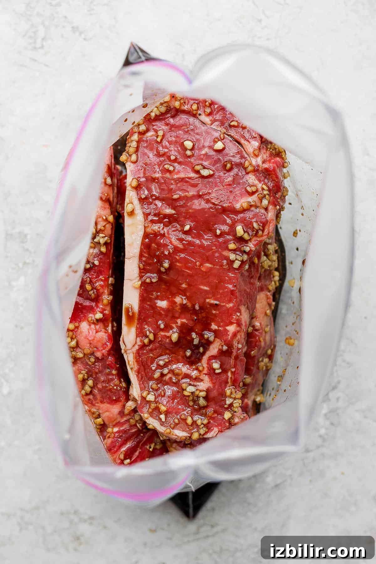 This is the ultimate steak marinade made with Worcestershire sauce, balsamic vinegar, garlic, and a little lemon juice. It'll leave your steak flavorful and juicy. steaks marinating in plastic bag.