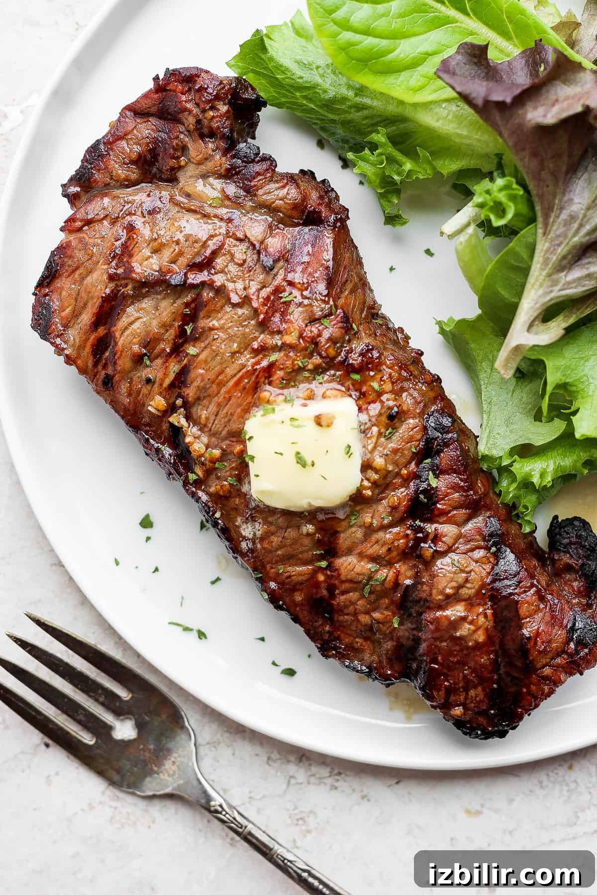 Grilled steak with butter steak on plate with butter.