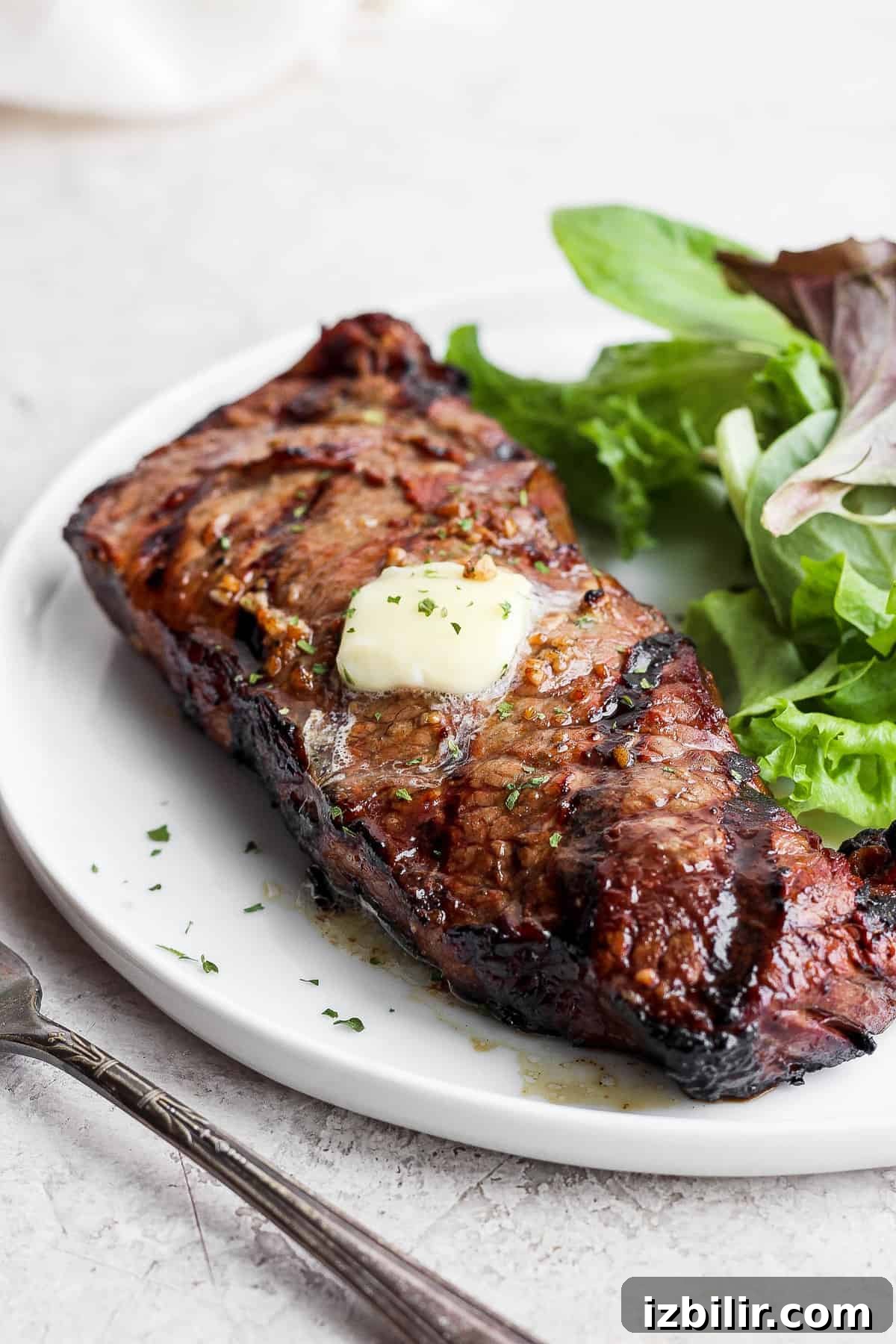 Steak with greens steak on a plate with greens.