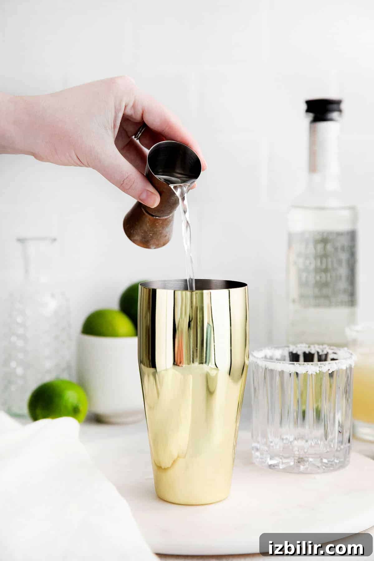 Classic Margarita Recipe: Tangy Lime and Tequila Cocktail 5 Tequila being poured into a cocktail shaker