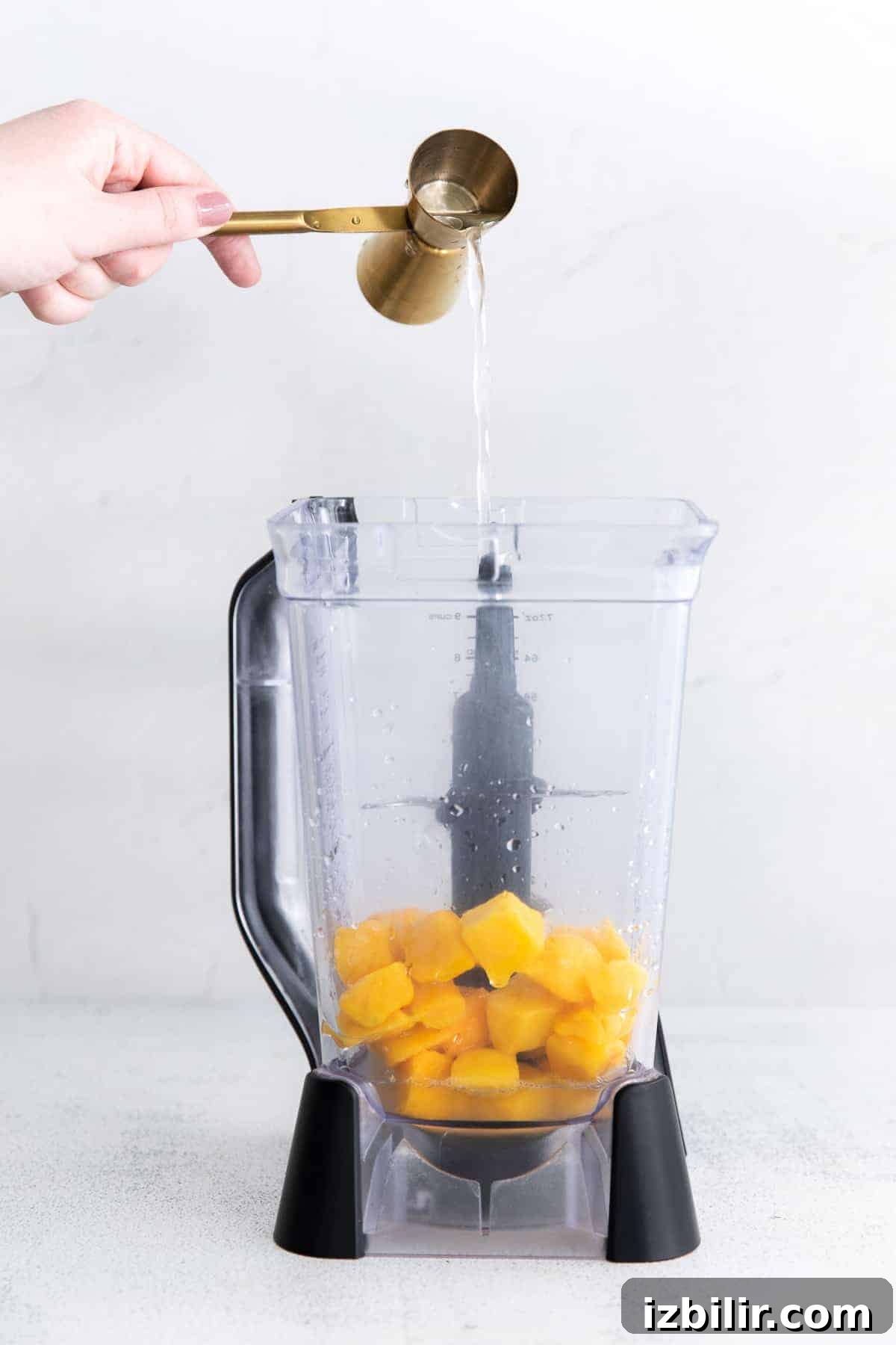 Frozen Mango Margarita Recipe with Tequila 3 pouring tequila into blender.