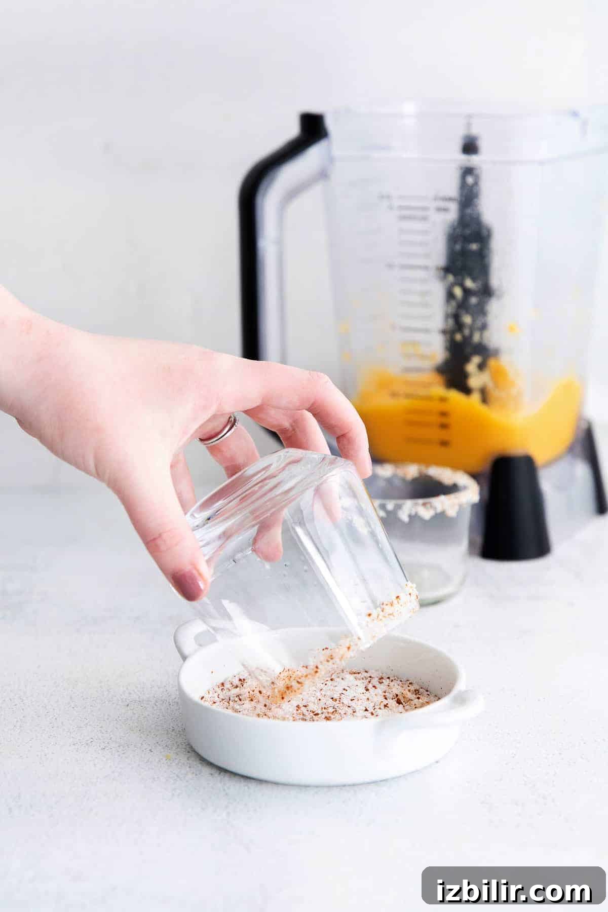 Frozen Mango Margarita Recipe with Tequila 5 salting the rim of a glass.