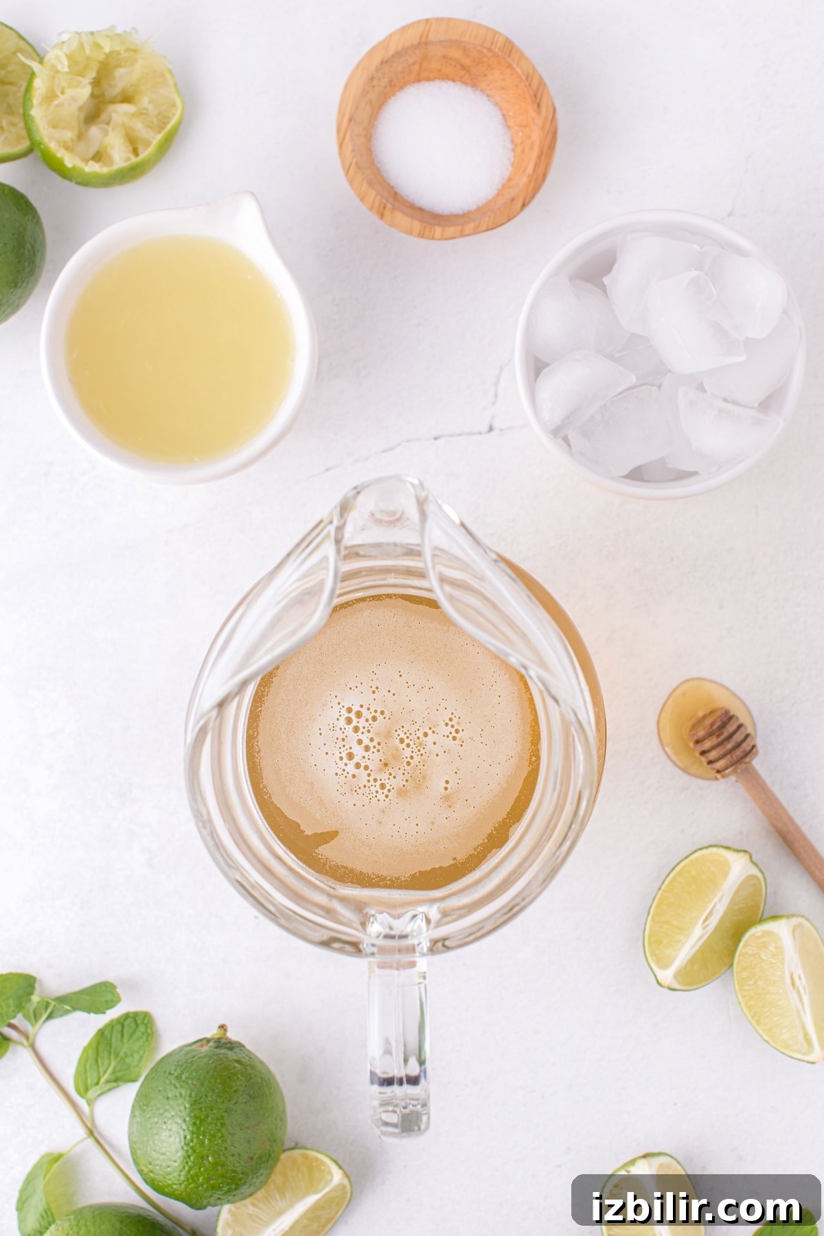 limeade in a pitcher with the rest of the limeade recipe ingredients next to it