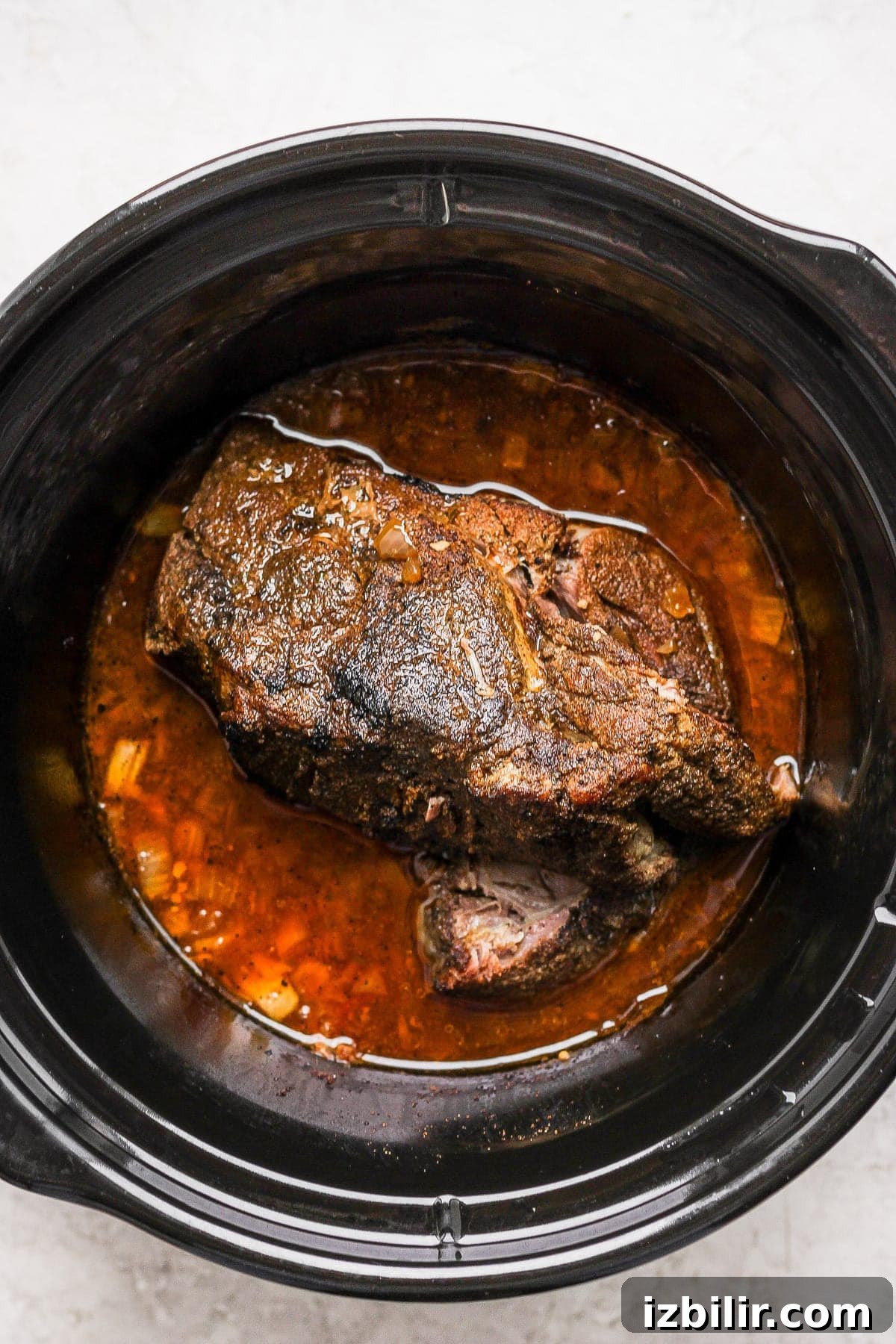 A pork roast in a slow cooker. 