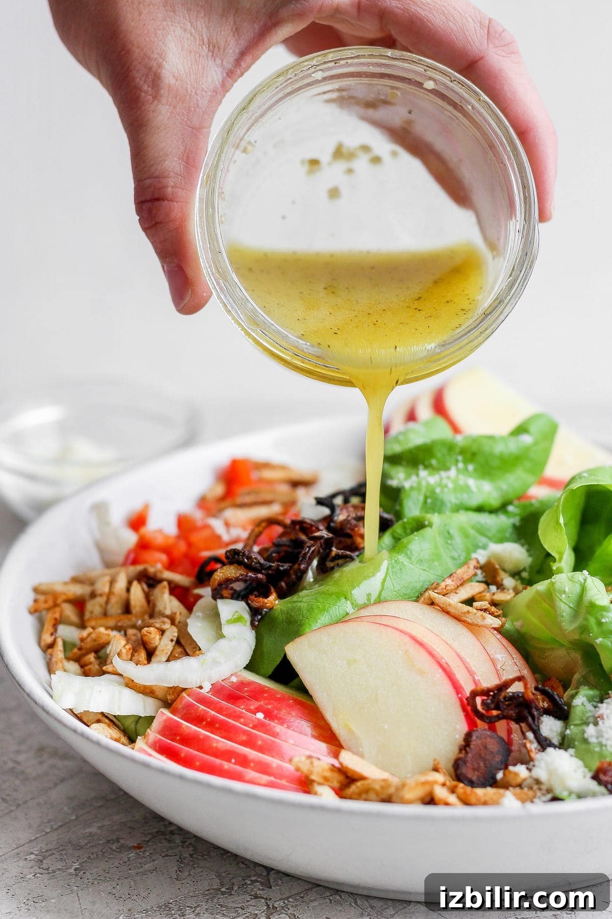 Butter Lettuce Salad with Lemon Dijon Vinaigrette 6 Pouring lemon vinaigrette over the butter lettuce salad