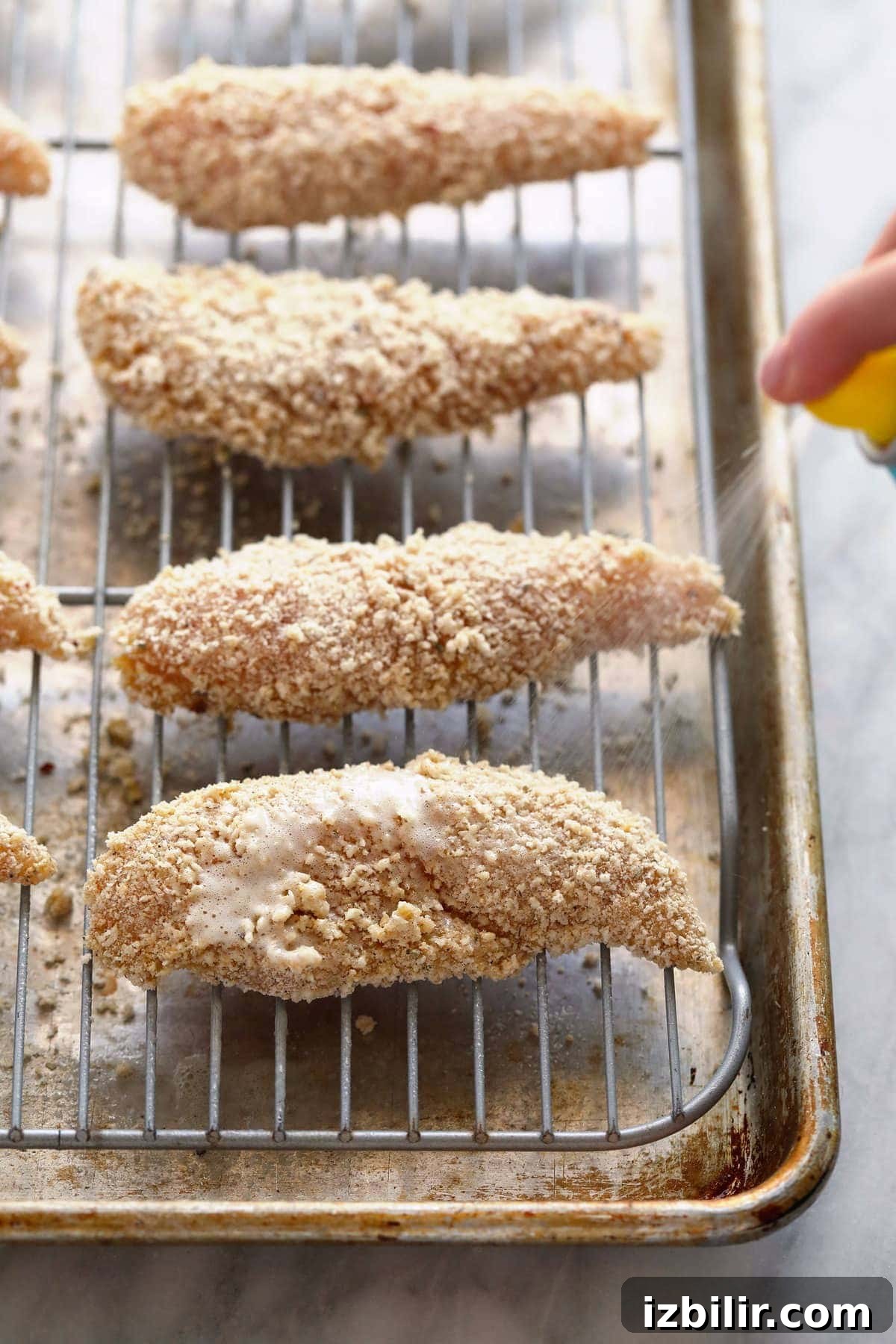Chicken tenders on a baking rack.