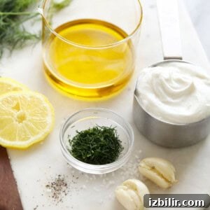 the ingredients for a dill dressing are on a cutting board.