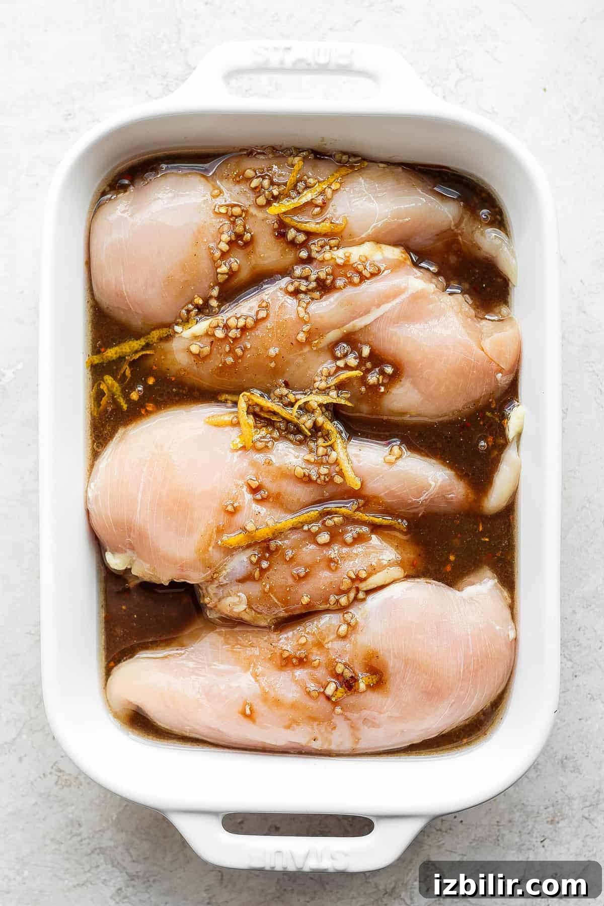 Grilled Bruschetta Chicken Recipe with Tomato Basil Topping 3 Chicken breasts marinating in chicken marinade.