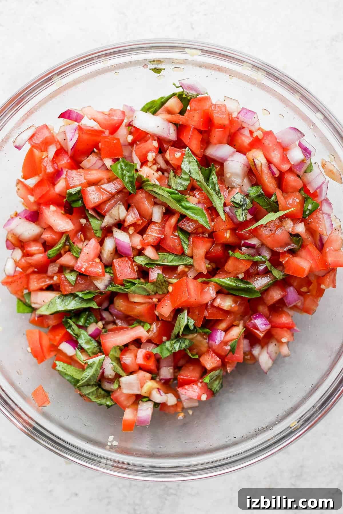 Grilled Bruschetta Chicken Recipe with Tomato Basil Topping 6 A bowl of bruschetta with fresh basil.