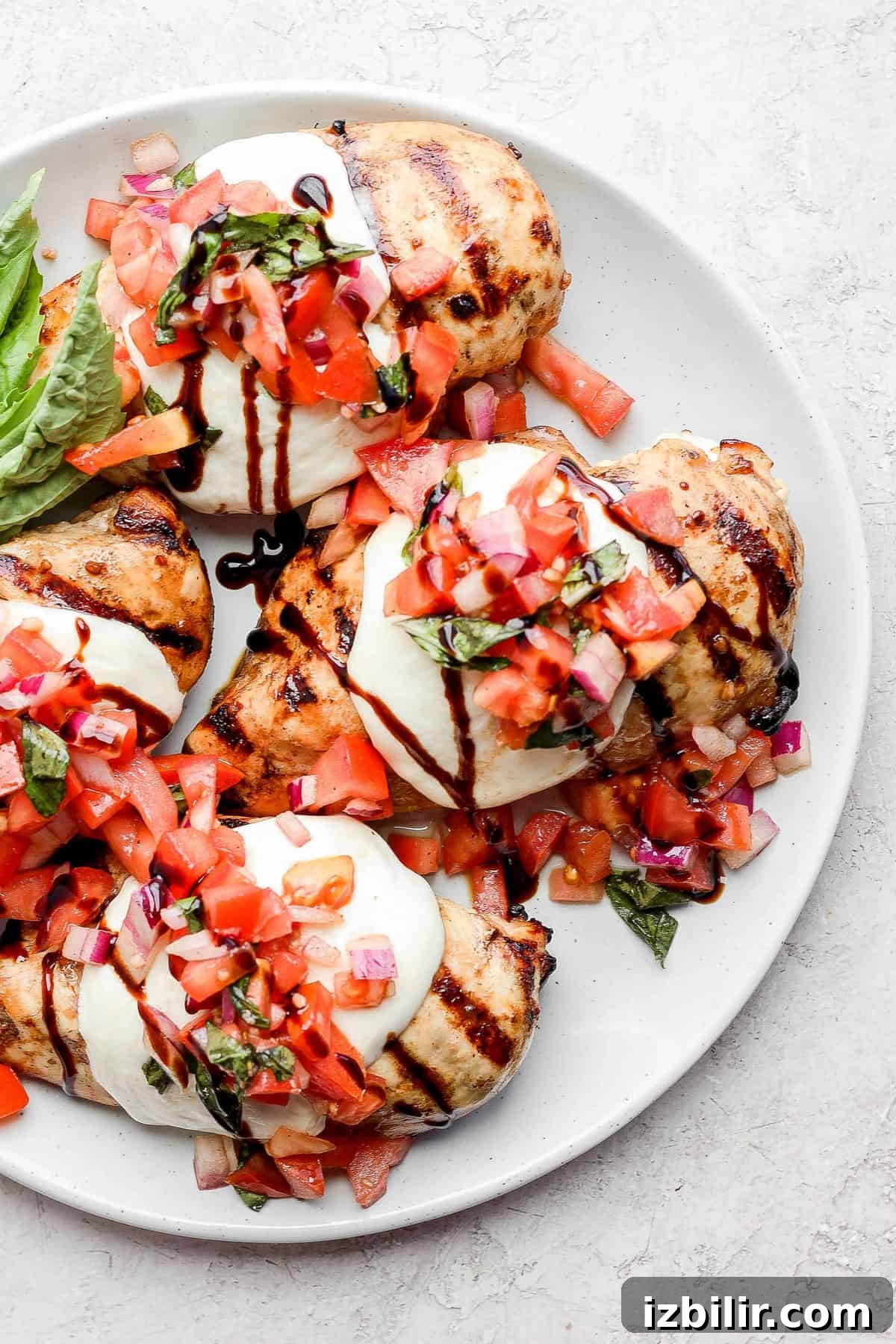 Grilled Bruschetta Chicken Recipe with Tomato Basil Topping 7 Bruschetta chicken topped with mozzarella, tomato, and a balsamic glaze drizzle.