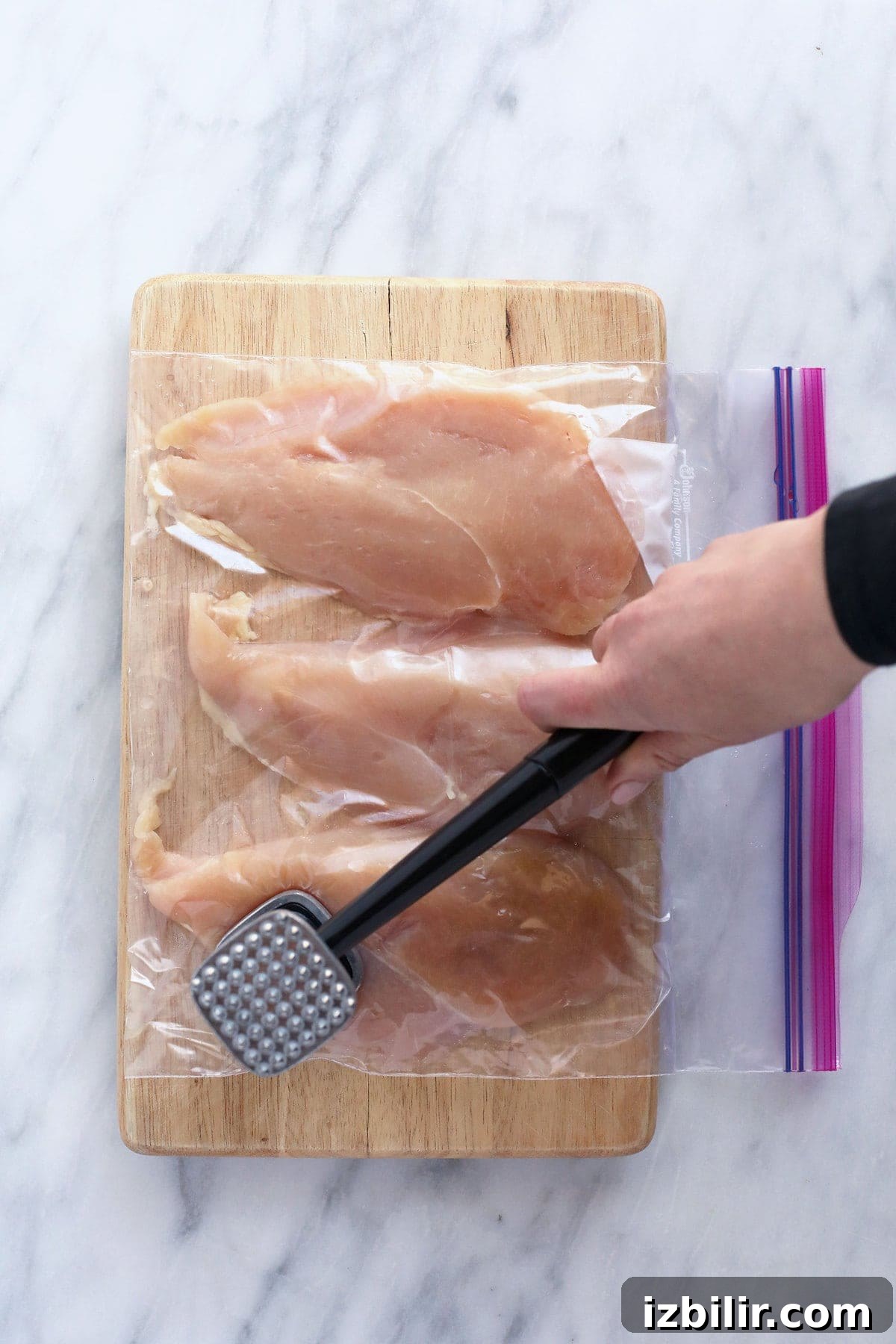 pounding chicken with meat tenderizer