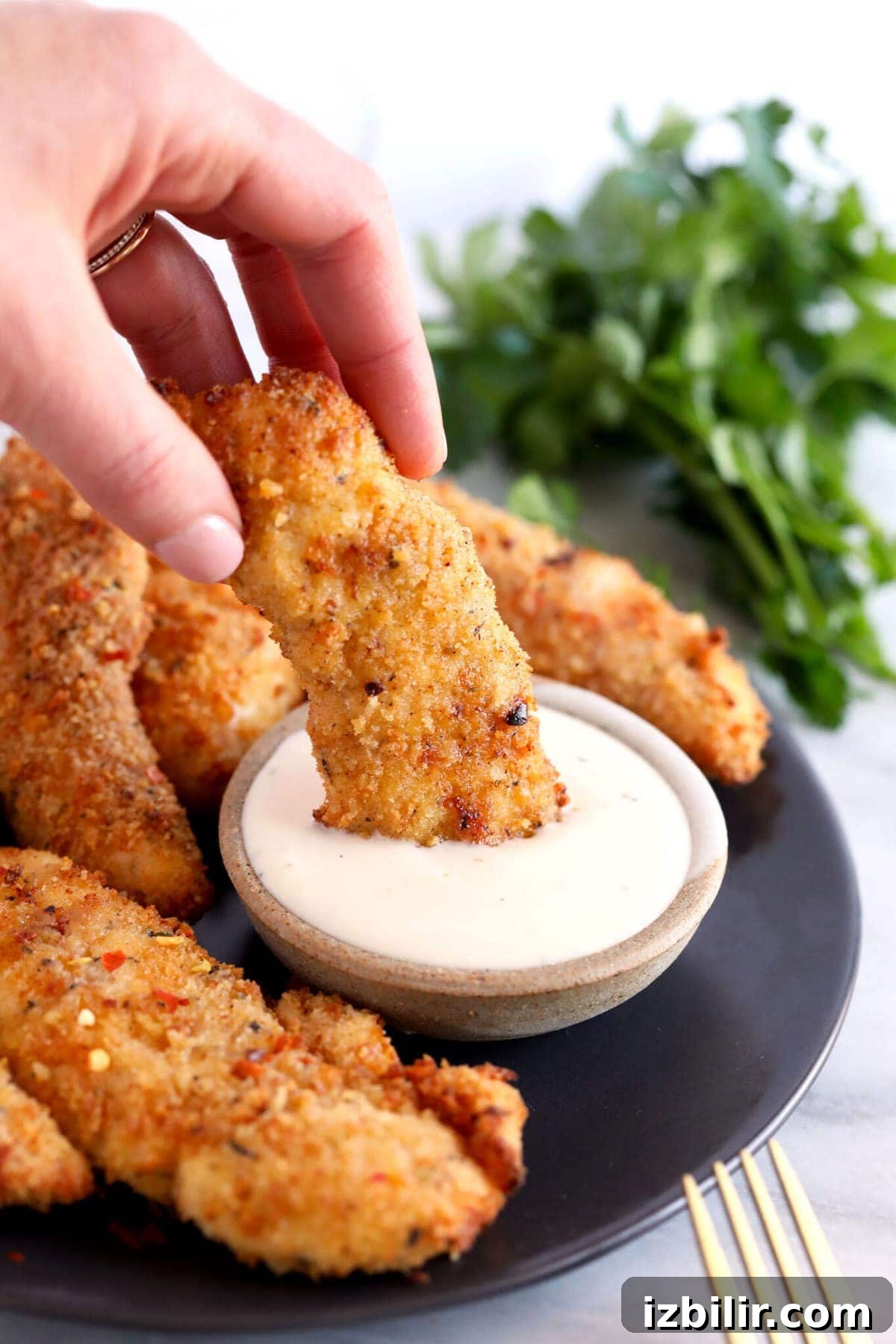 dipping chicken tender in ranch