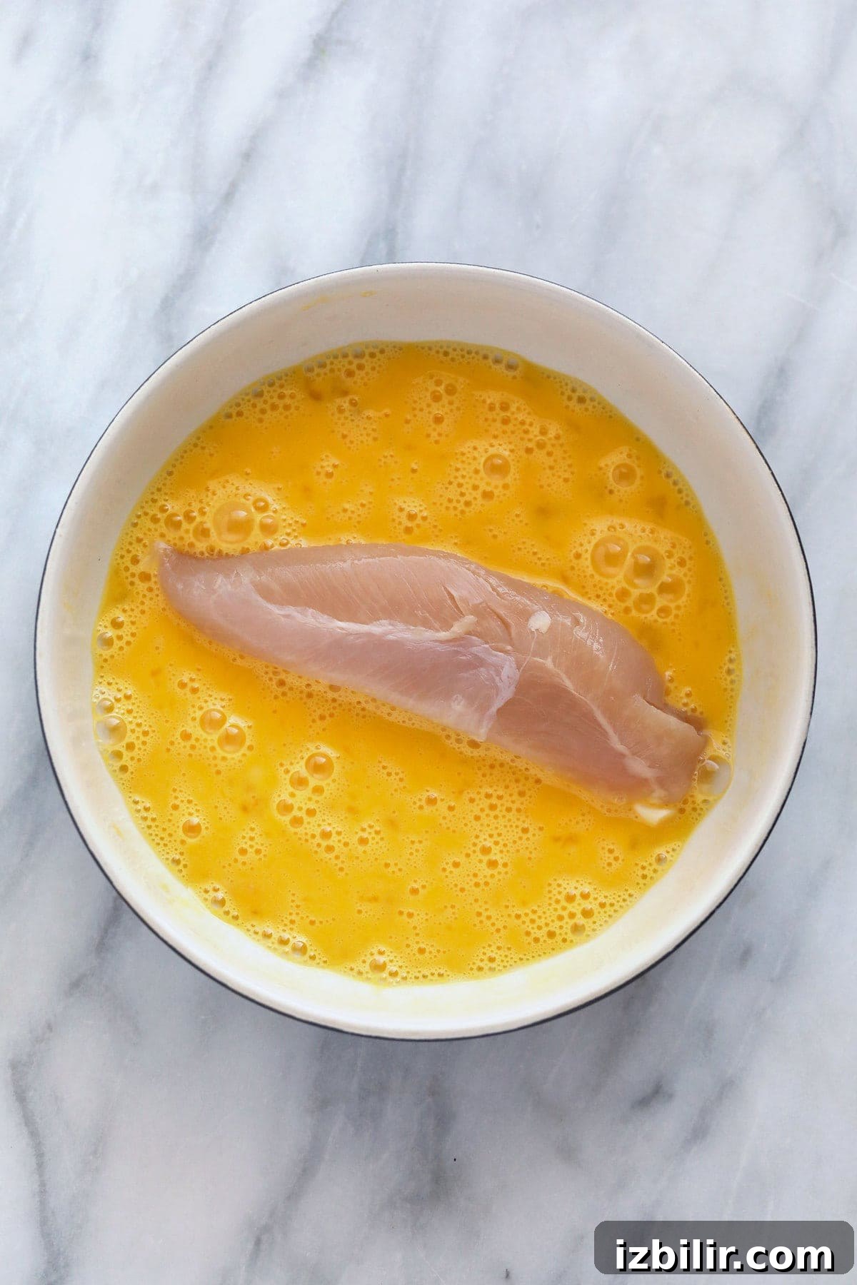 dipping chicken tenderloin in egg wash