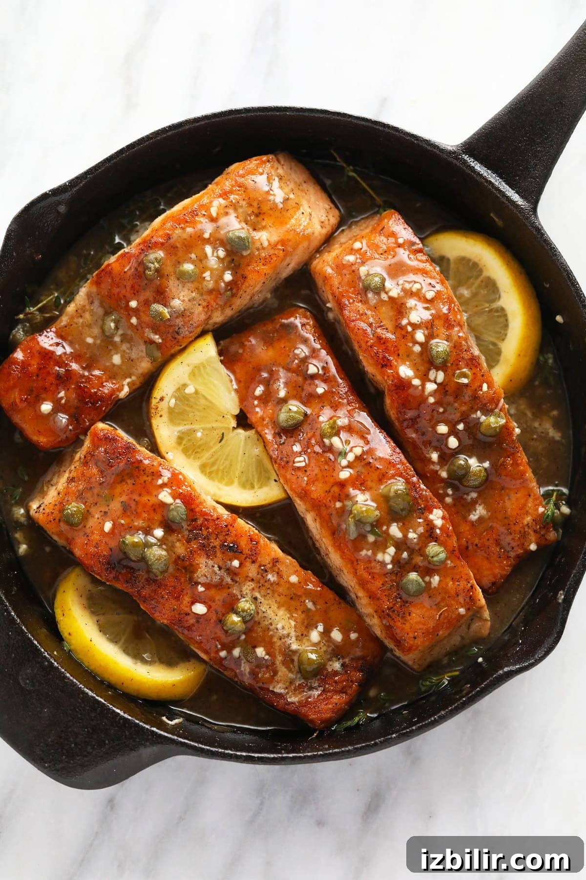 Pan-Seared Salmon Piccata with Lemon Caper Sauce 2 Salmon piccata in a cast iron.