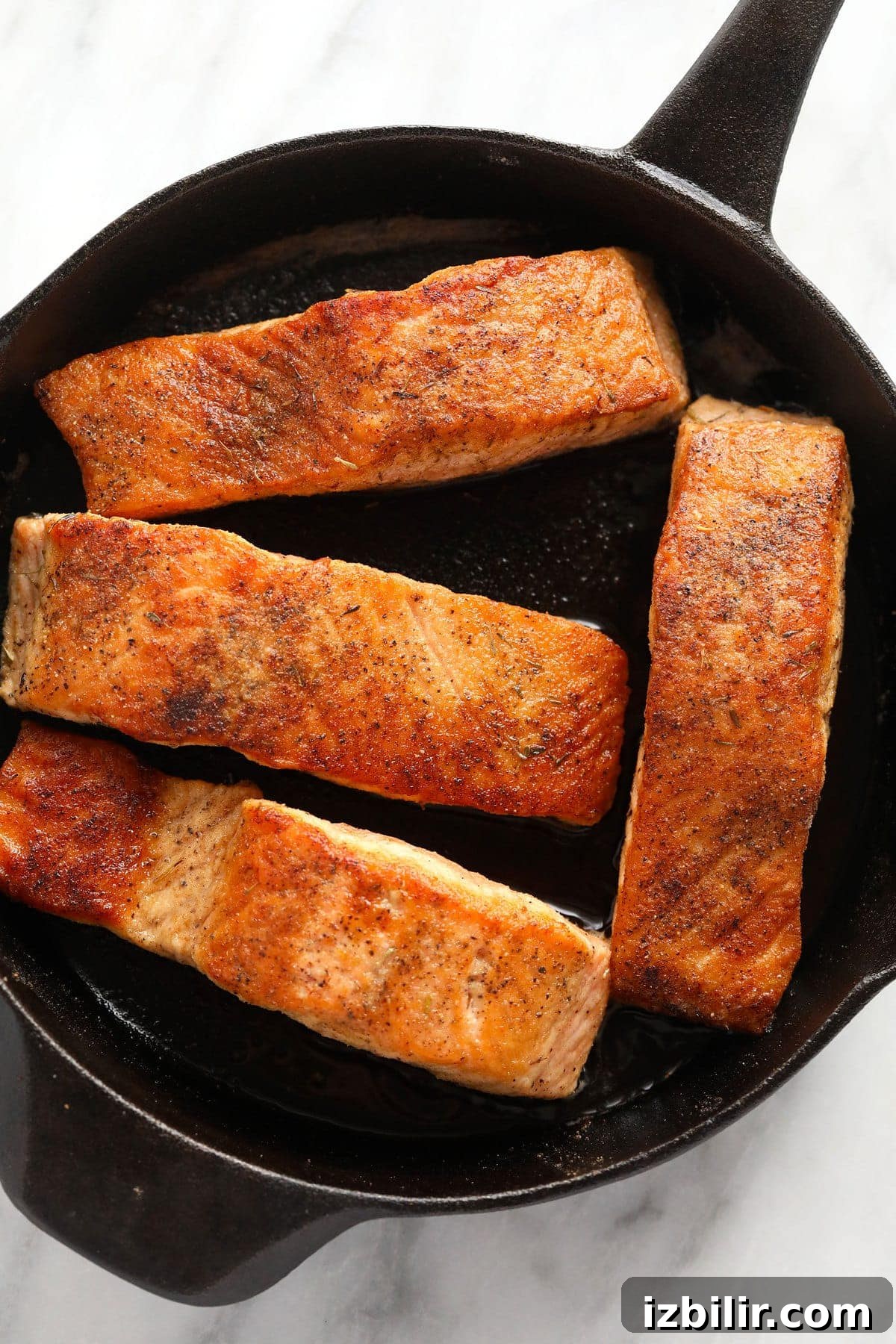Pan-Seared Salmon Piccata with Lemon Caper Sauce 5 Salmon filets in a cast iron.