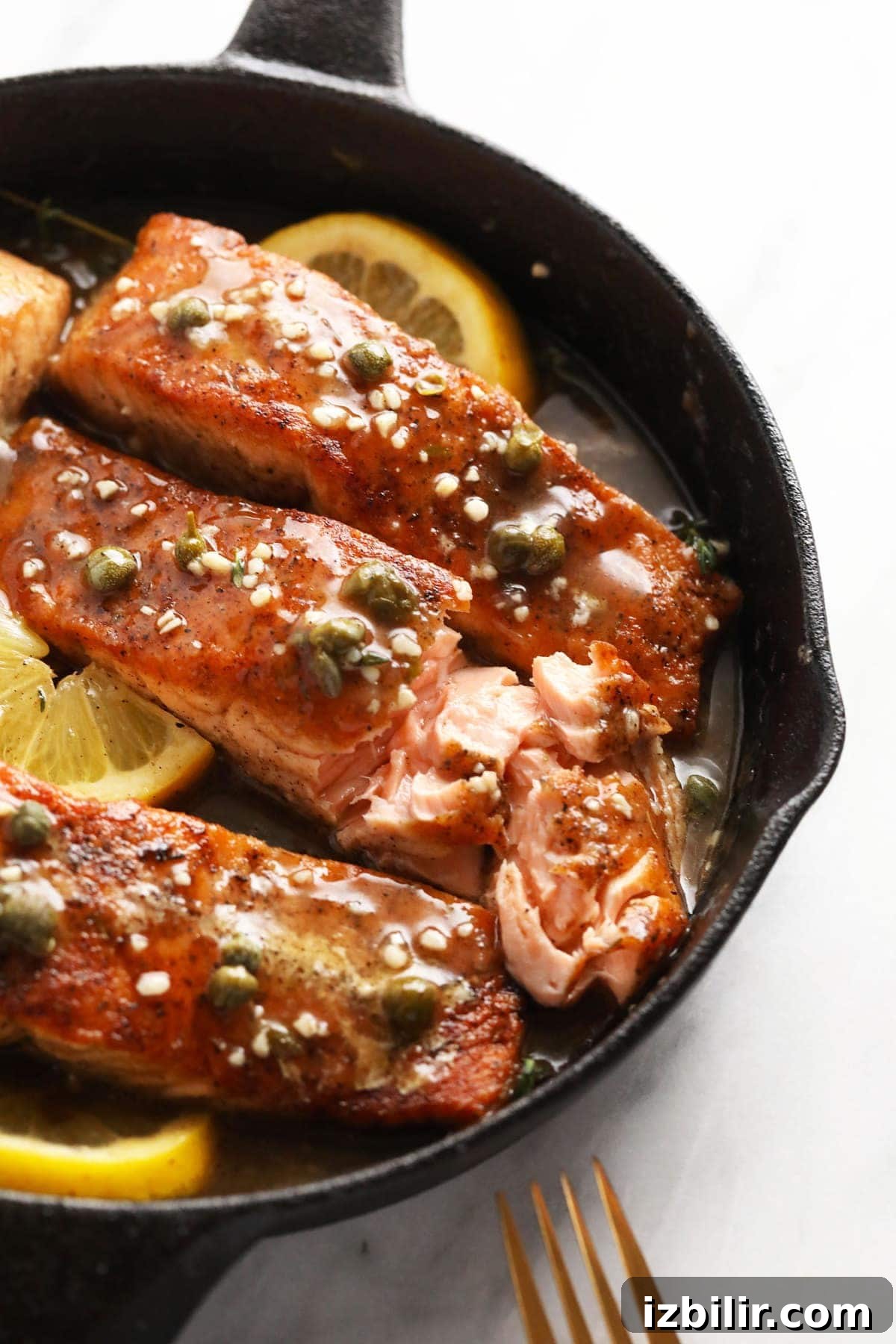 Pan-Seared Salmon Piccata with Lemon Caper Sauce 8 Salmon piccata in a cast iron pan,