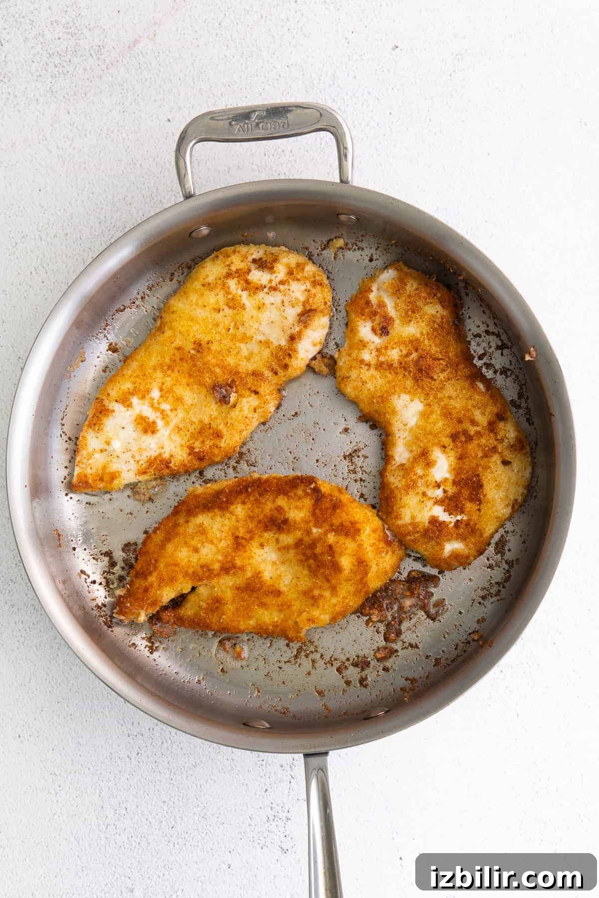 Parmesan Crusted Chicken Parmesan crusted chicken in frying pan.