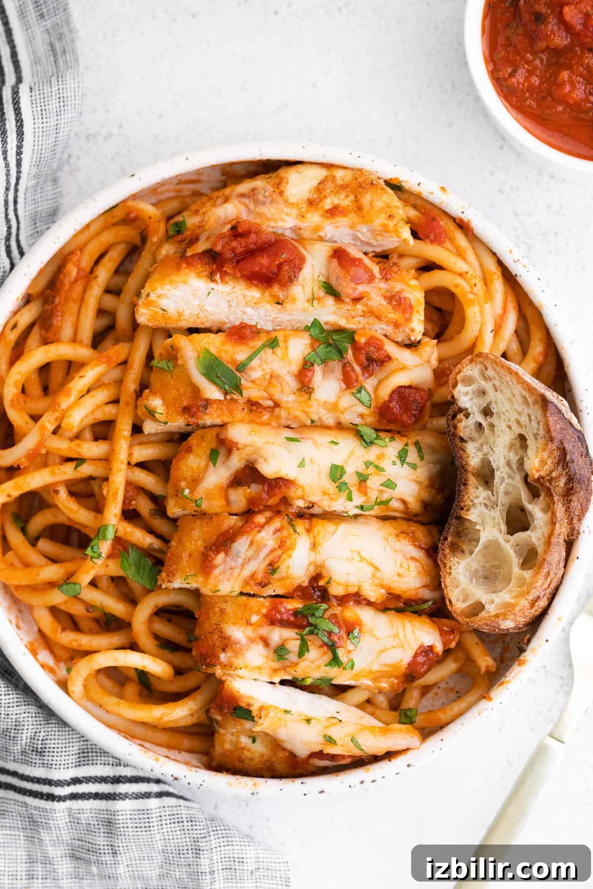 Sliced Chicken Parmesan Sliced chicken parmesan on noodles.