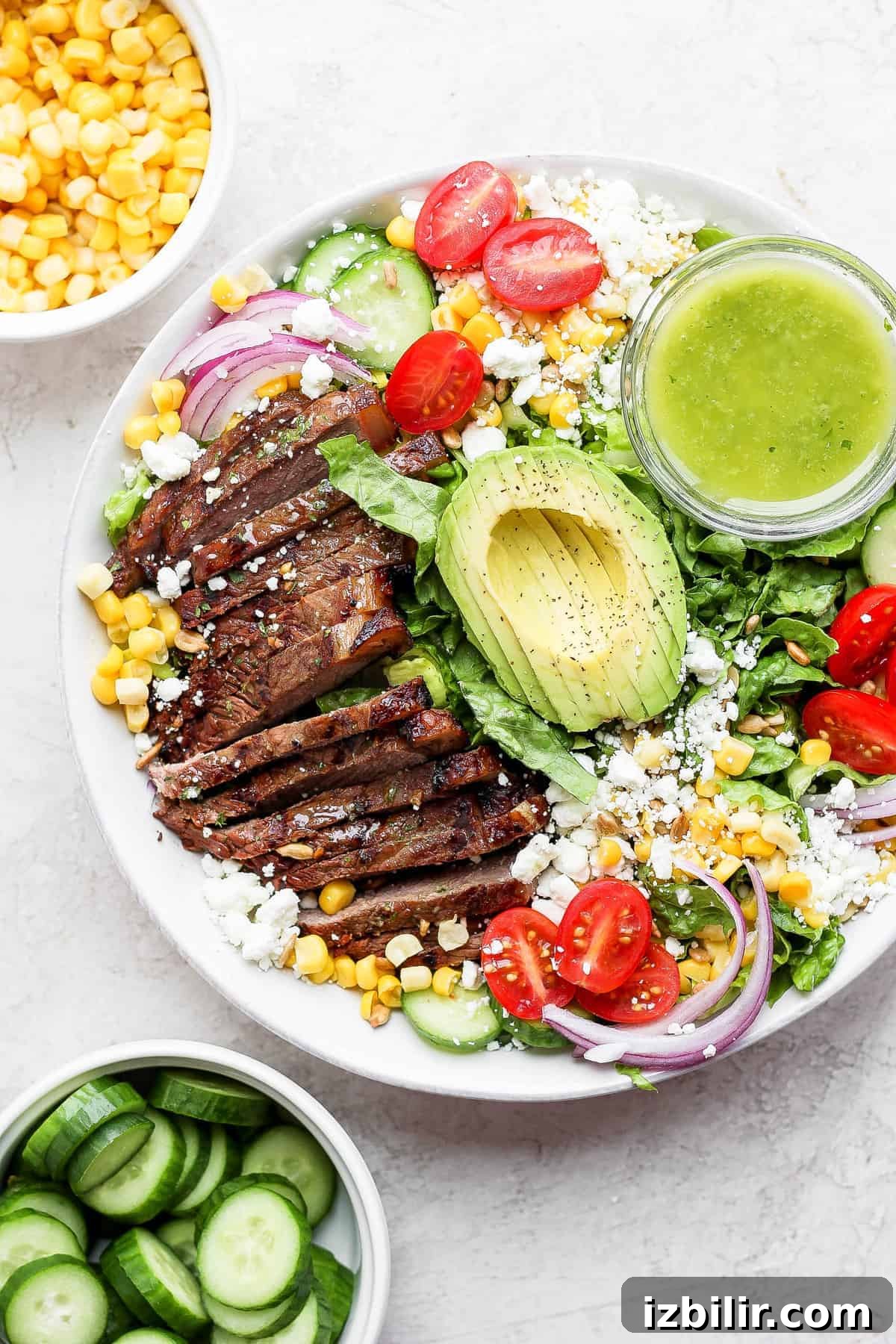 steak salad in bowl with dressing.