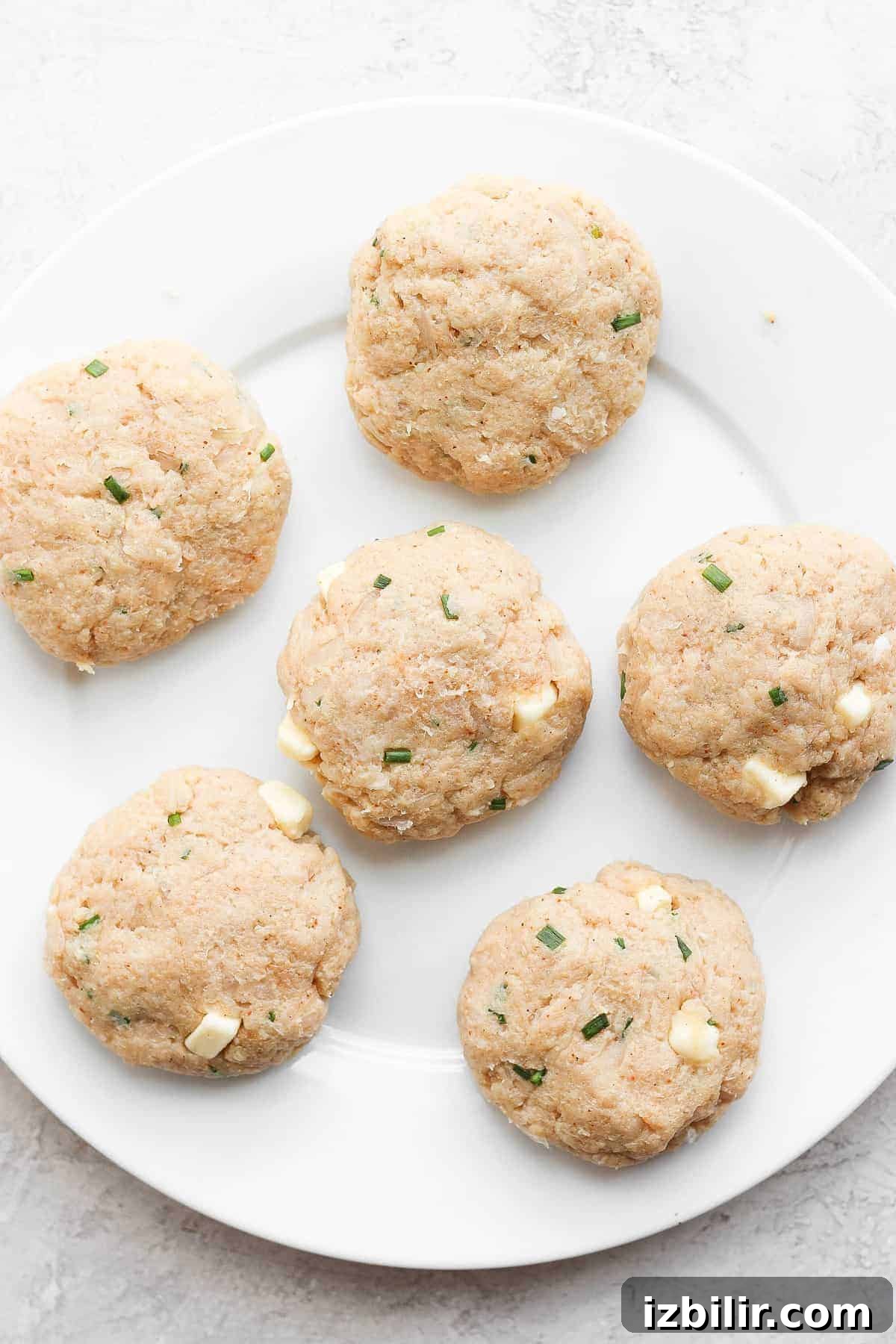 ground chicken burger patties on plate.