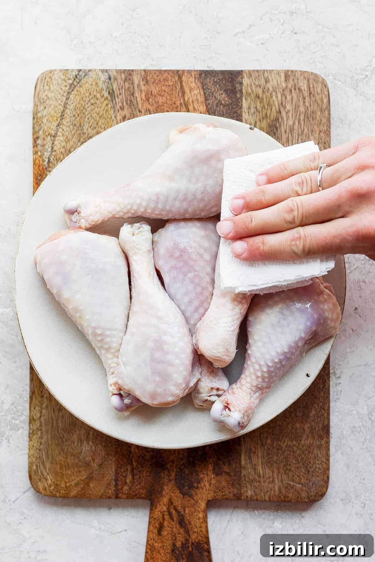 Pat the chicken legs dry before applying the dry rub. patting chicken legs with paper towel