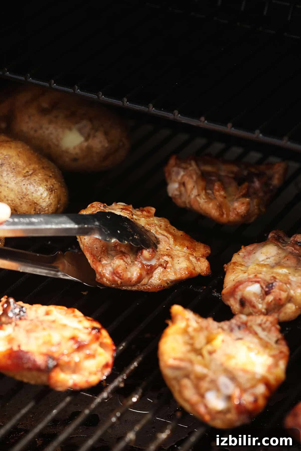 How to Smoke Chicken Thighs for Juicy, Crispy Skin 6 Flipping chicken thighs on a smoker.