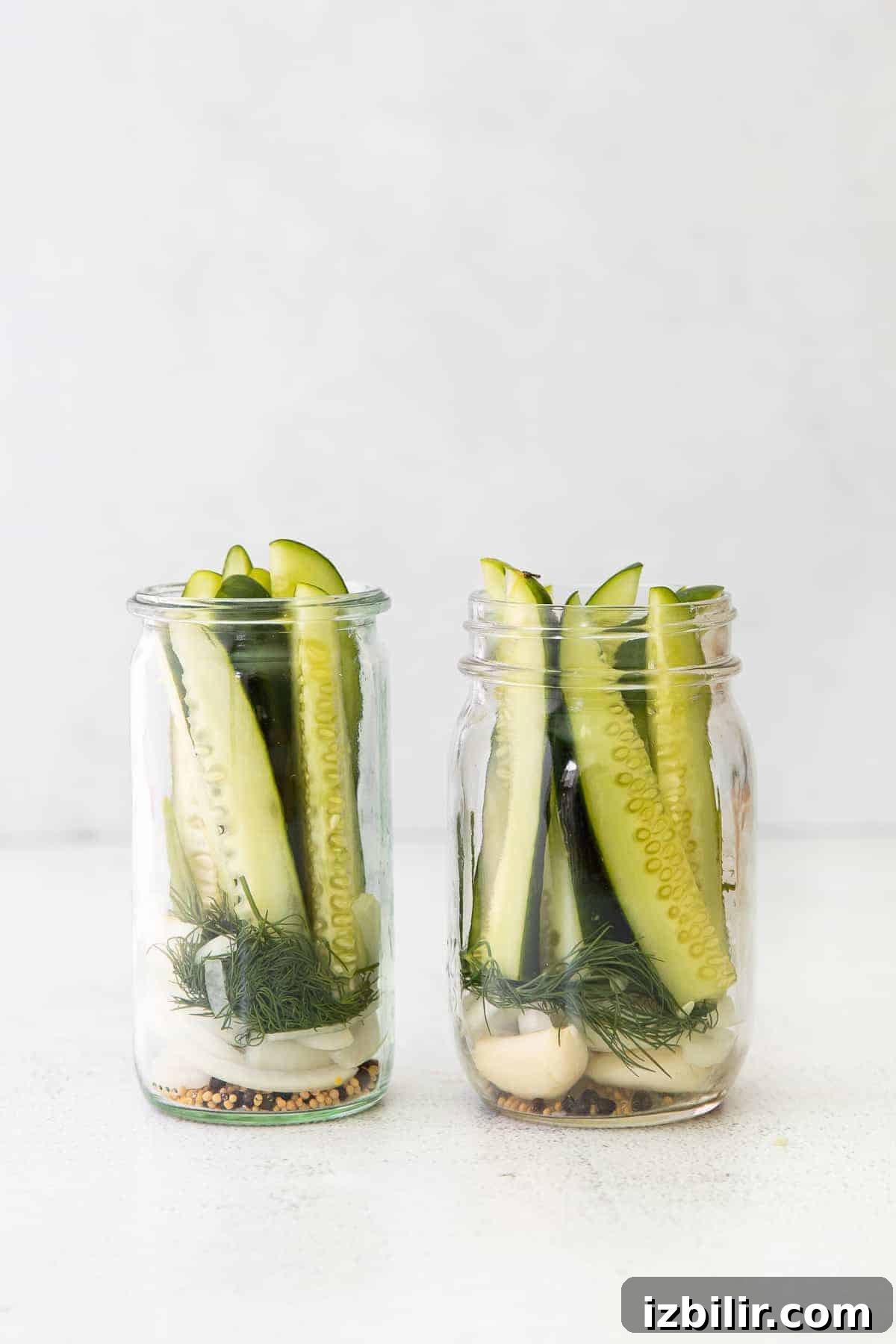 Refrigerator pickle ingredients in two mason jars. 