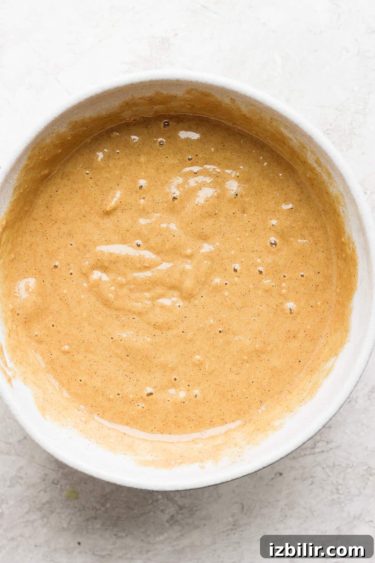 Peach muffin batter before baking. peach muffin batter in a bowl