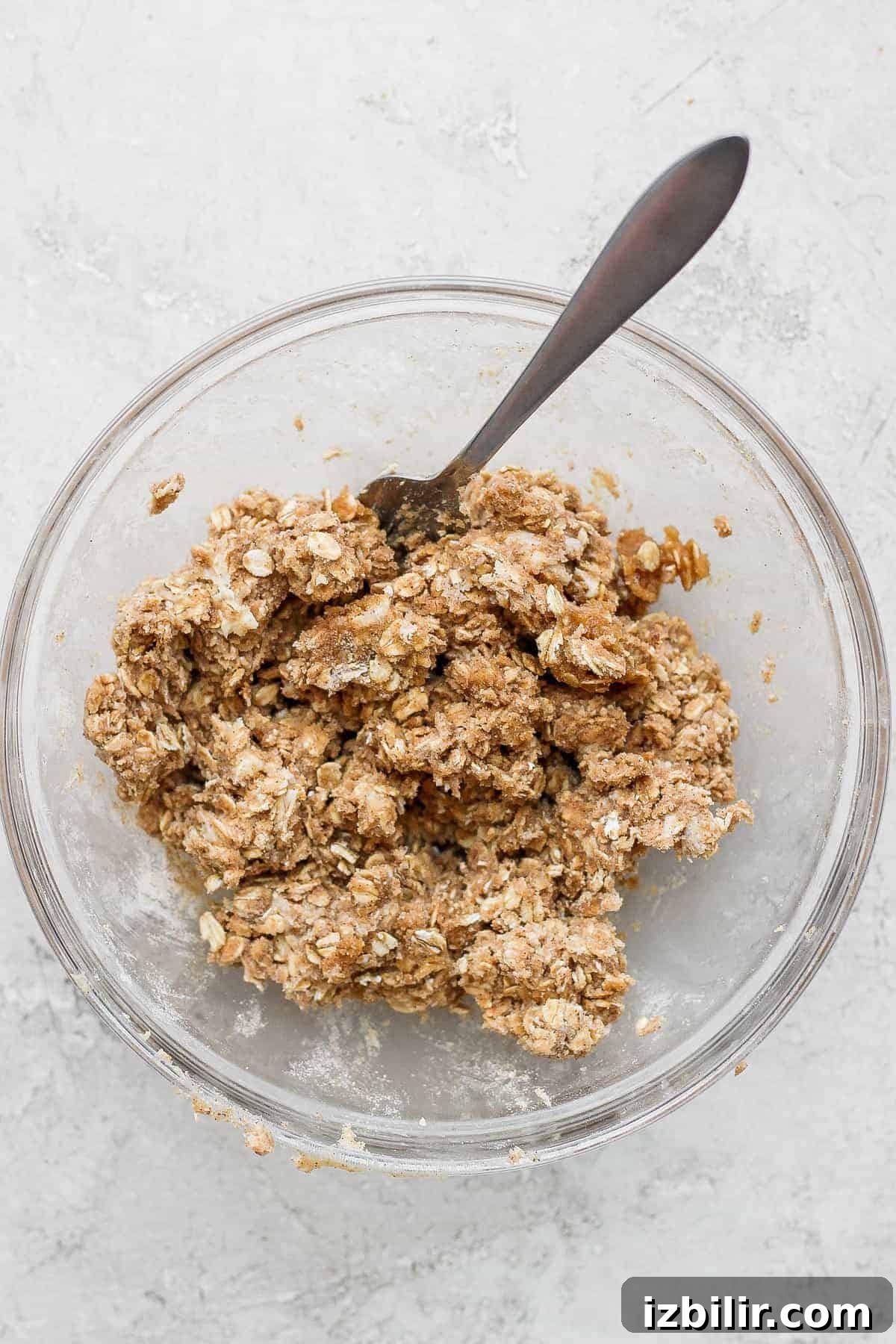 Crumble topping made from oats, flour, and butter. Peach crisp crumble topping in a bowl.