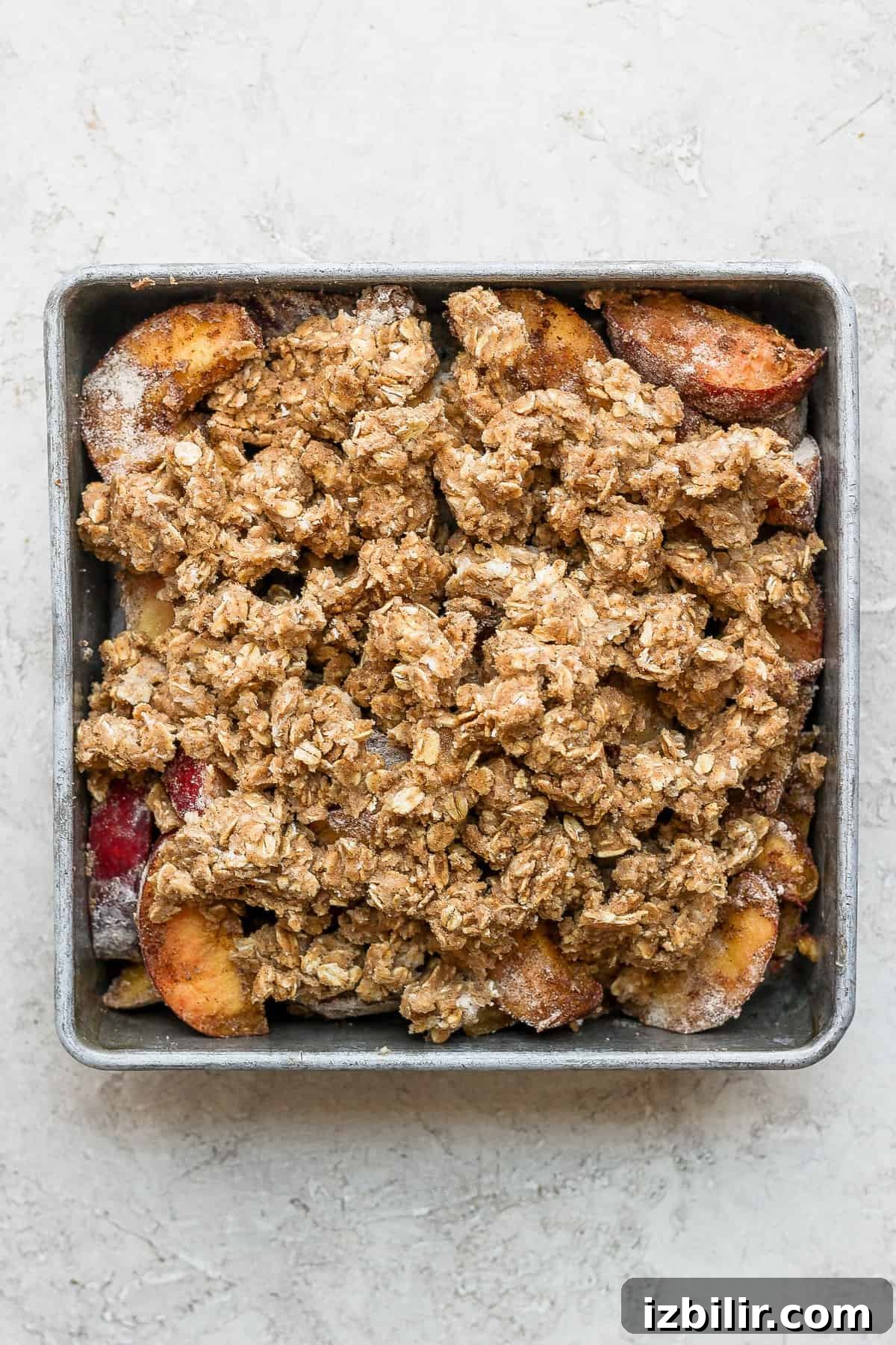 Peach crisp ready to bake. Peach crisp with crumble topping ready to be baked.
