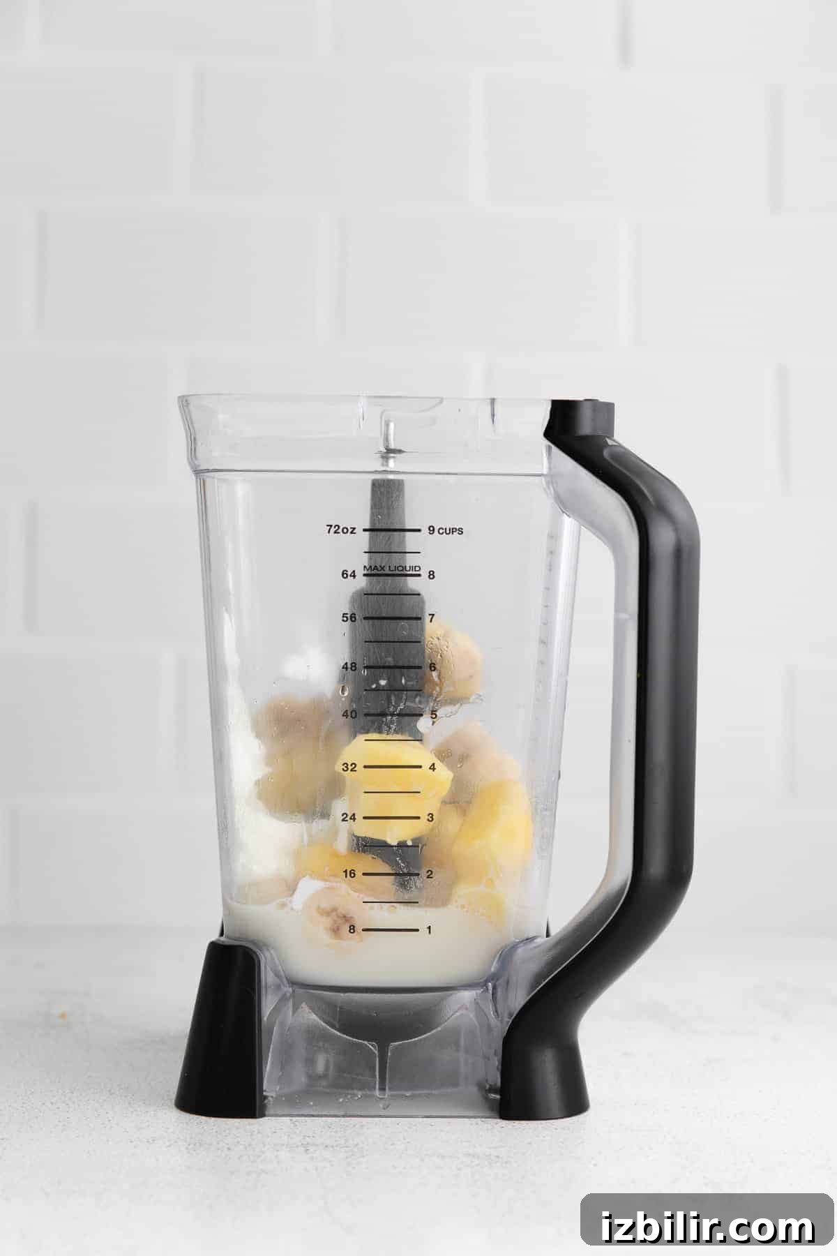 This pineapple smoothie recipe is so refreshing it tastes like vacation. It's made with frozen pineapple, banana, Greek yogurt, and pineapple juice! smoothie ingredients in blender