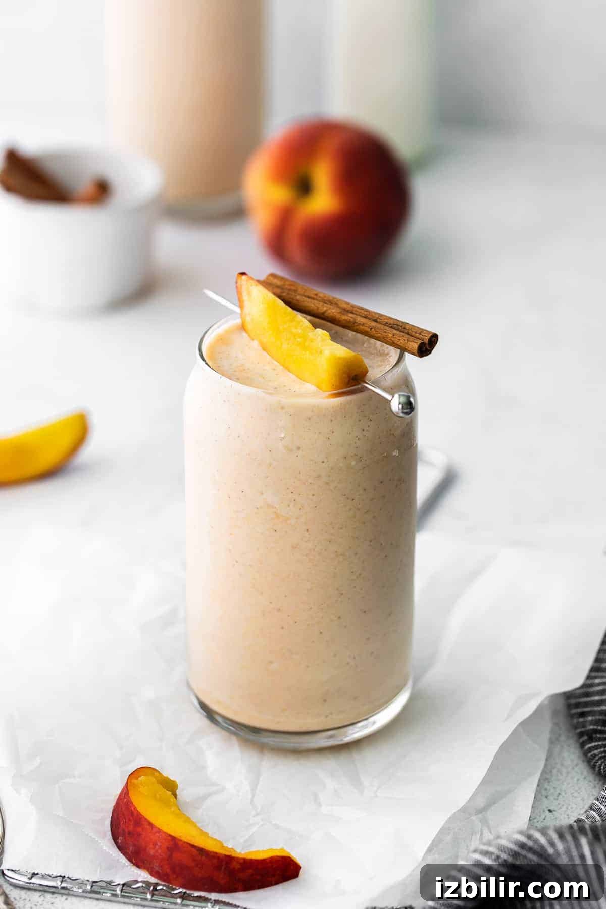 peach smoothie with fresh peach and cinnamon stick