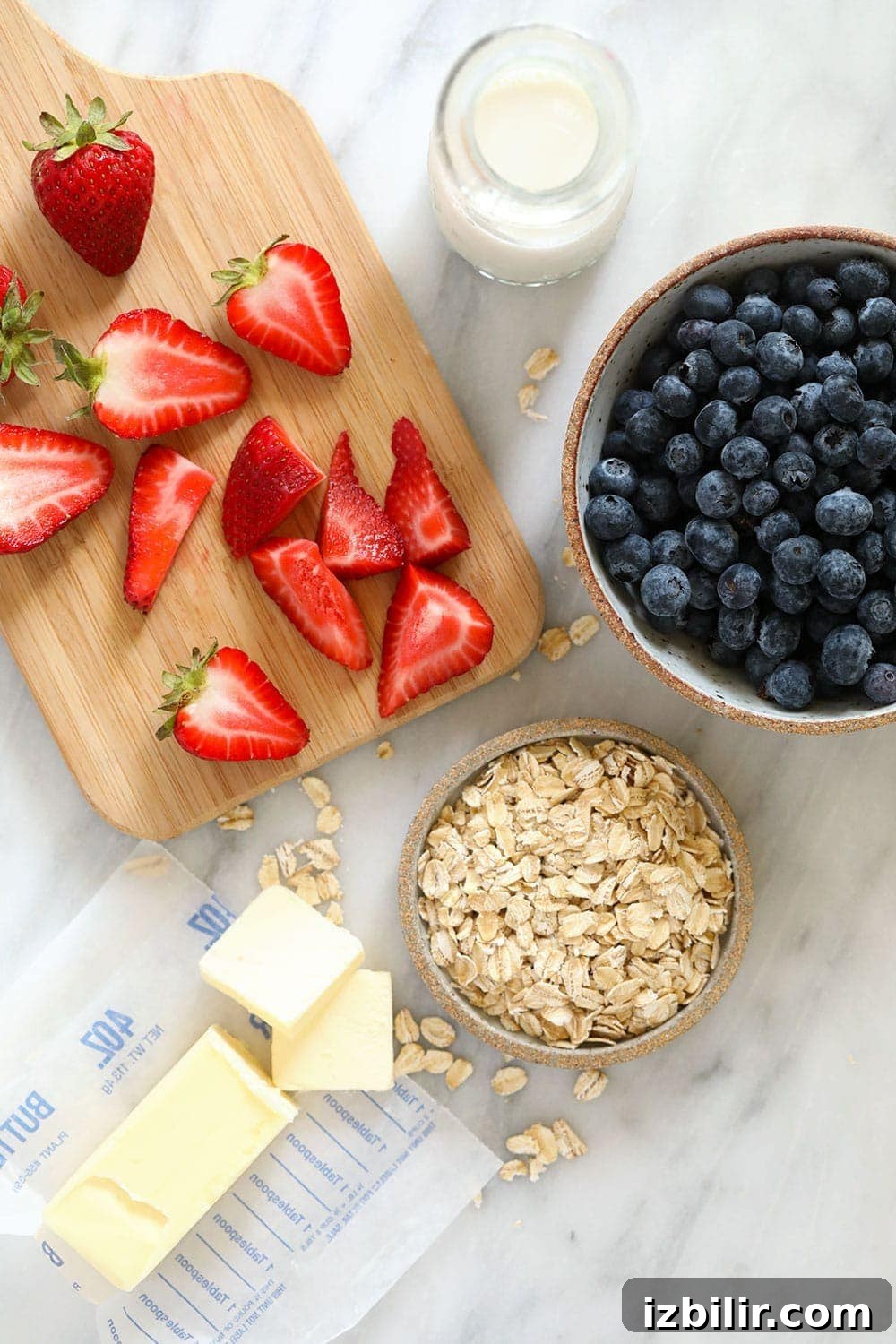 Make this berry crisp recipe using fresh or frozen berries, rolled oats, brown sugar, and a squeeze of lemon juice! rolled oats, sliced strawberries, butter, milk, and blueberries