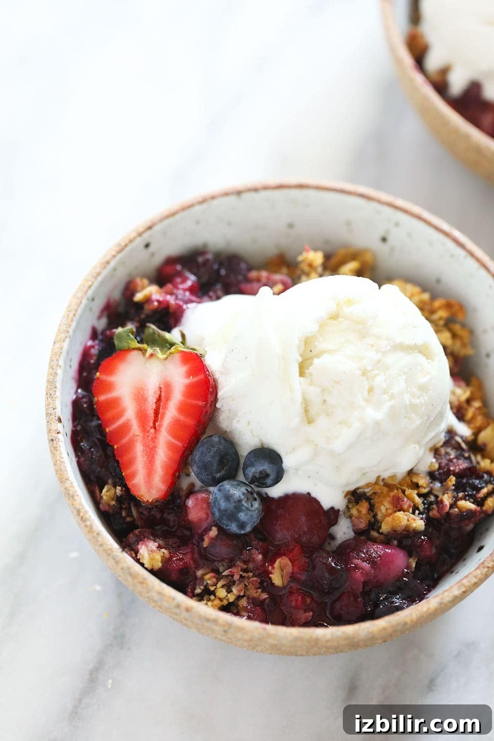 Serve berry crisp hot with a scoop of vanilla ice cream. bowl of berry crisp with vanilla ice cream