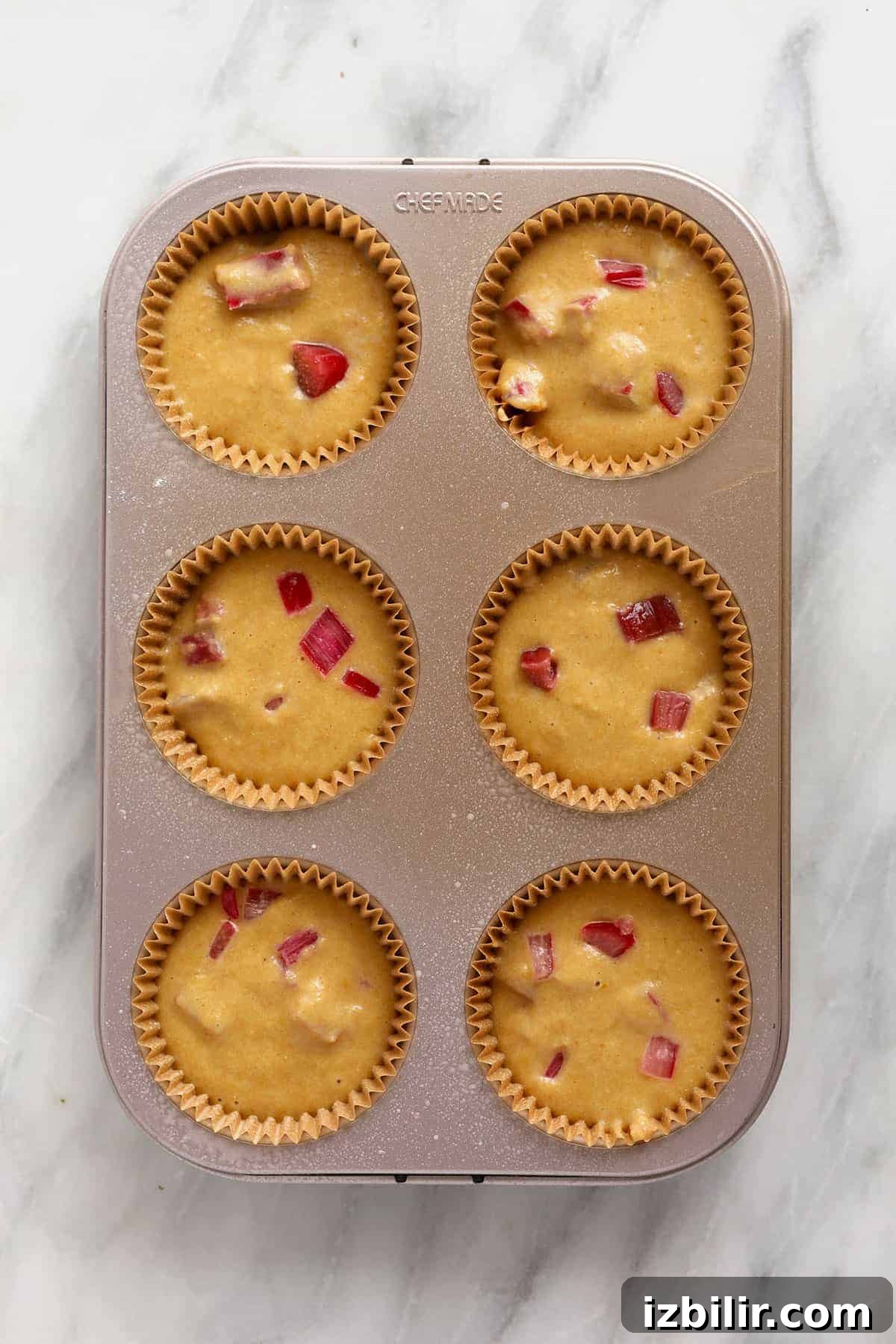 Lemon-Glazed Rhubarb Muffins 6 Rhubarb muffin batter in a muffin pan