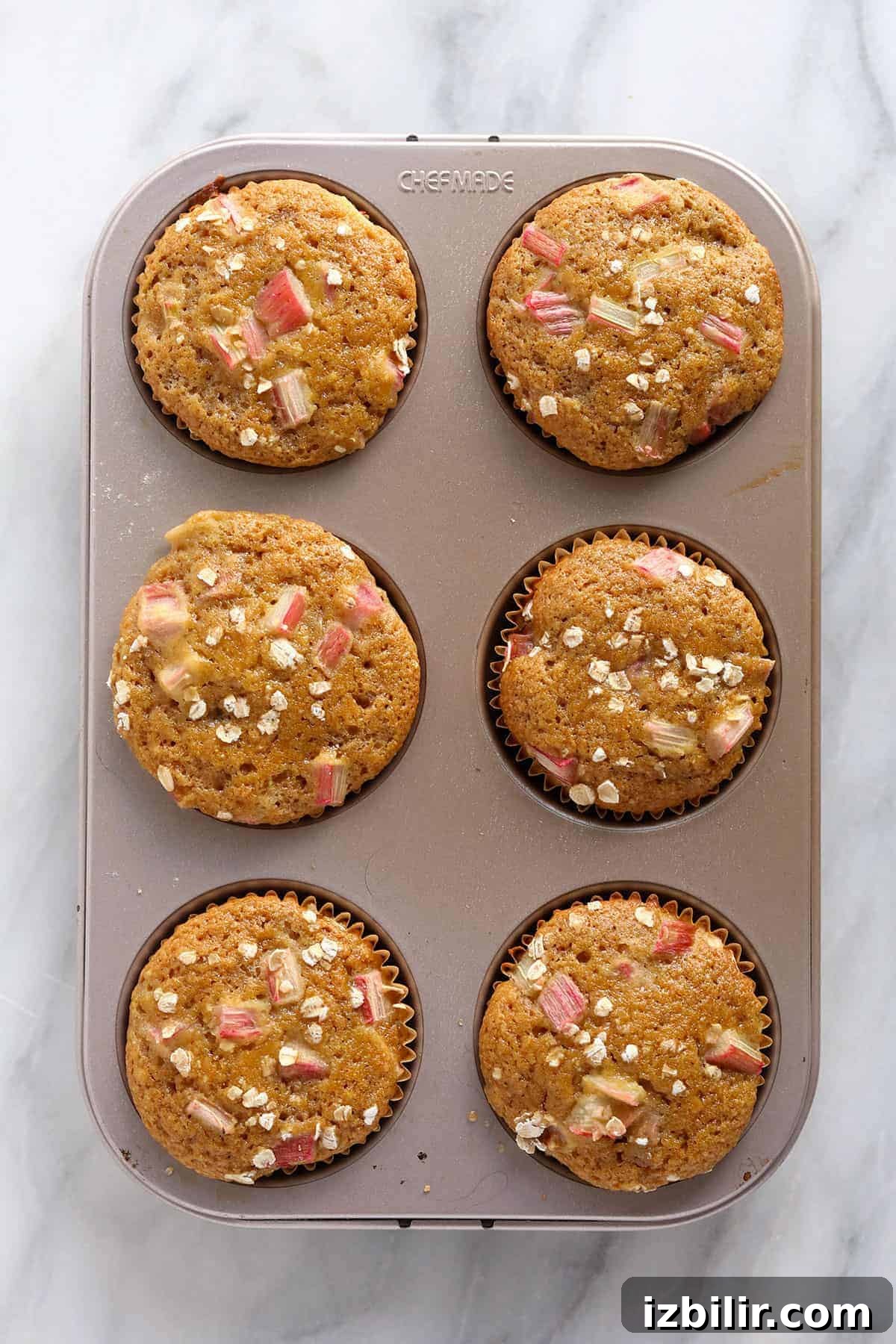 Lemon-Glazed Rhubarb Muffins 7 Rhubarb muffins in a muffin tin