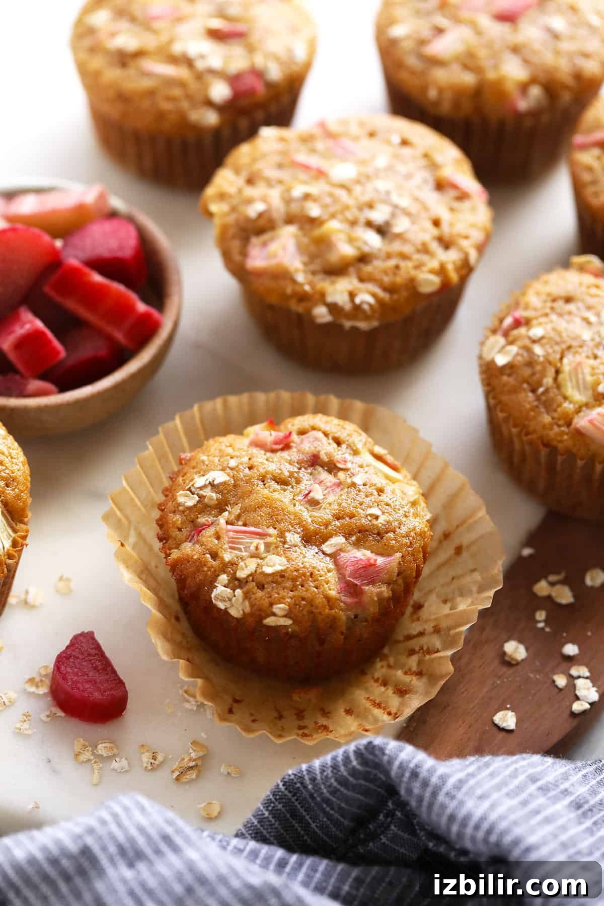 Lemon-Glazed Rhubarb Muffins 10 Rhubarb muffins on a counter top.
