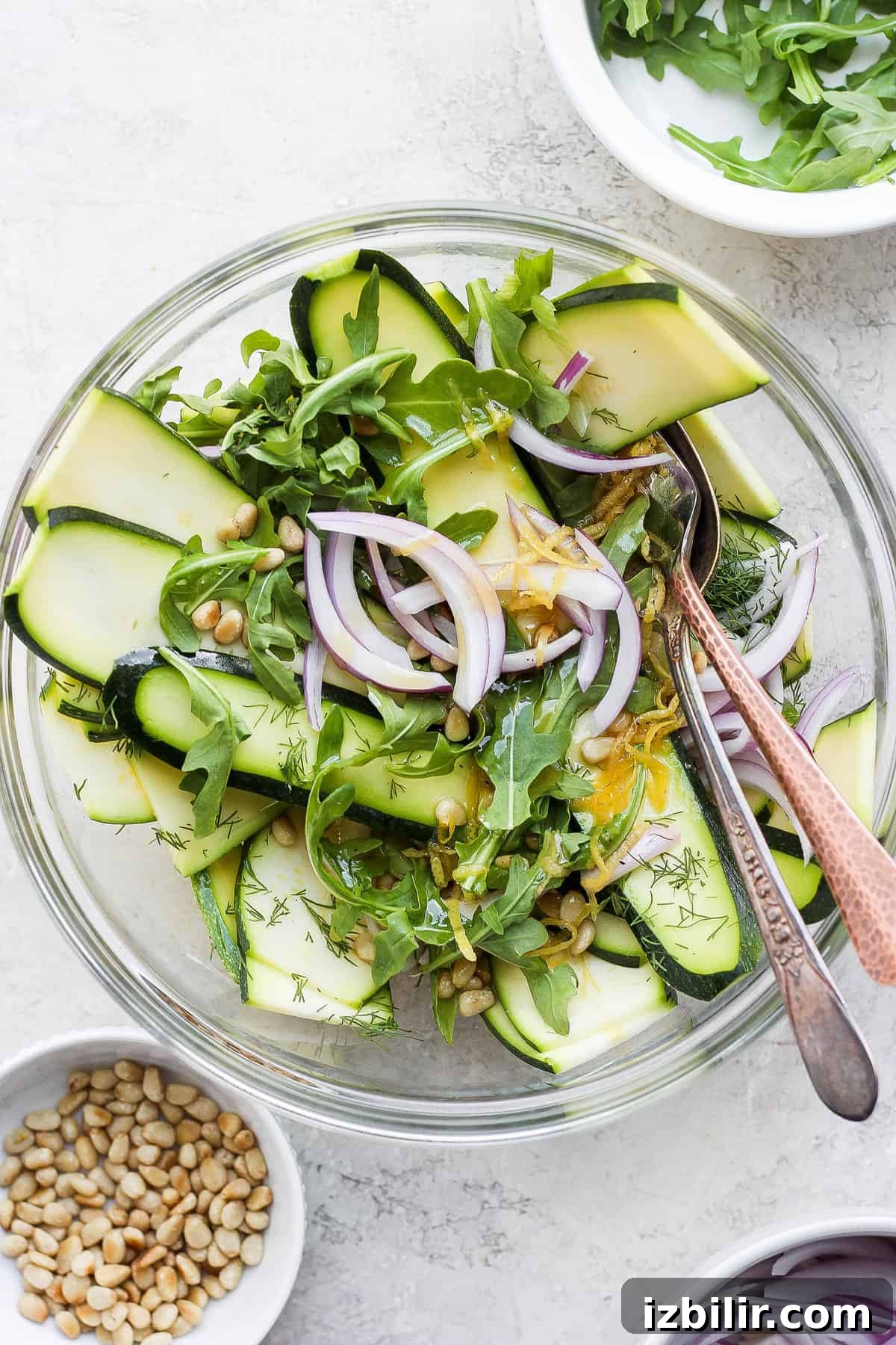 This zucchini salad is a fresh and flavorful side for any summer meal. And with a short list of ingredients and a deliciously fresh homemade dressing, this salad is ready to serve in no time. zucchini salad in a bowl, ready to be served