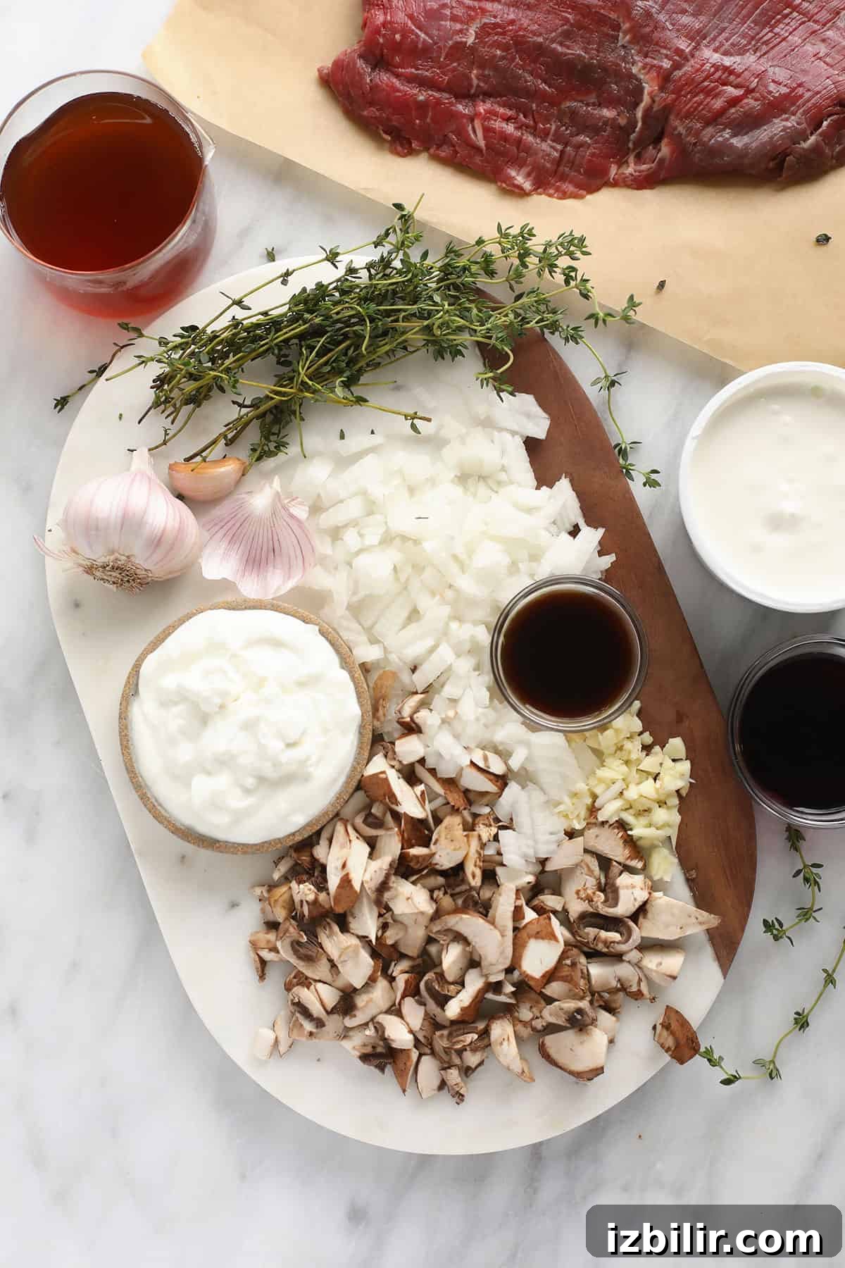 Ingredients for beef stroganoff including sour cream, Greek yogurt, beef and mushrooms.