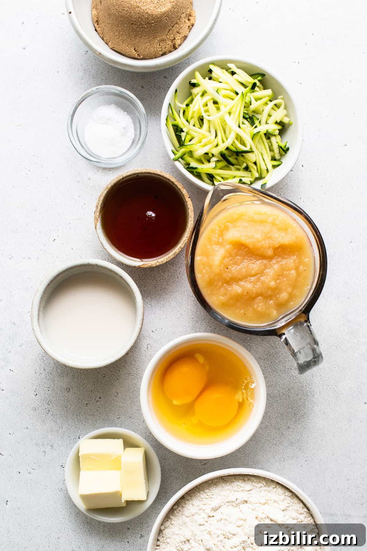 Moist Zucchini Bread with Cinnamon and Walnuts 3 A table topped with bowls filled with different types of food.