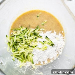 Moist Zucchini Bread with Cinnamon and Walnuts 8 A bowl filled with ingredients to make a dish.