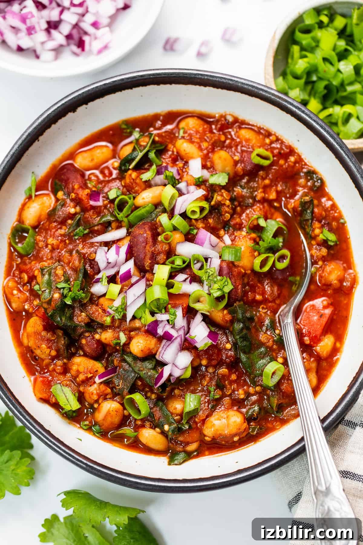 This nourishing quinoa chili recipe is packed with fiber, protein, and so many veggies. bowl of quinoa chili.