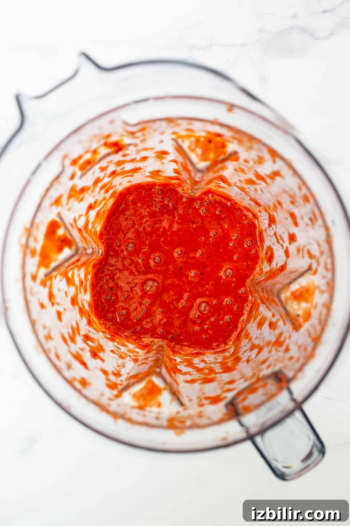 Blended roasted red peppers ready to be added to the chili. blended roasted red peppers in mixer.