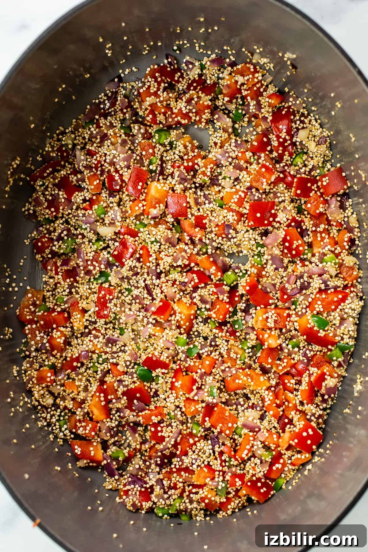 Quinoa chili simmering in a Dutch oven. cooking quinoa chili in Dutch oven.